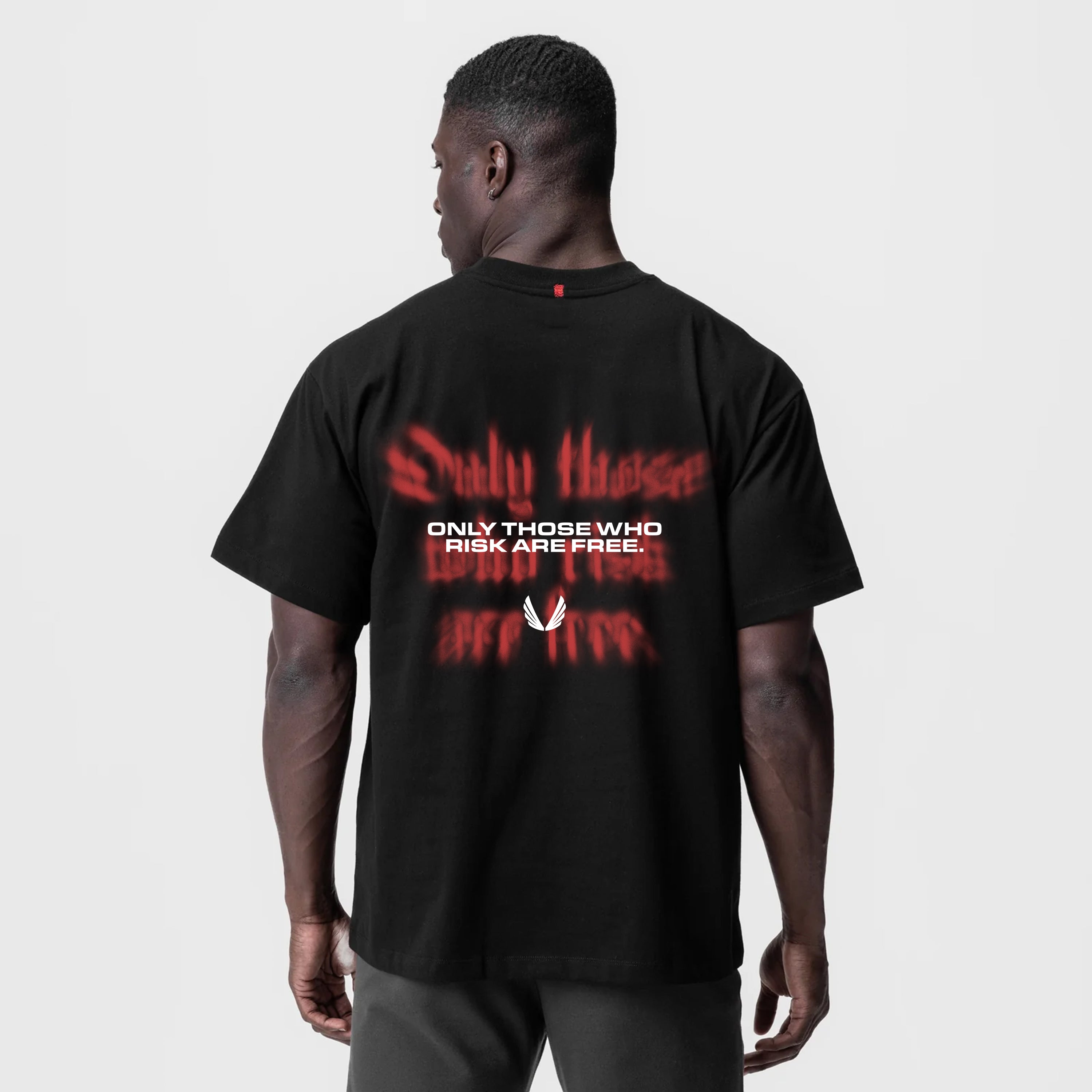Black Tech Essential Relaxed Tee with red 'Risk Protocol' back print, worn by model, back view