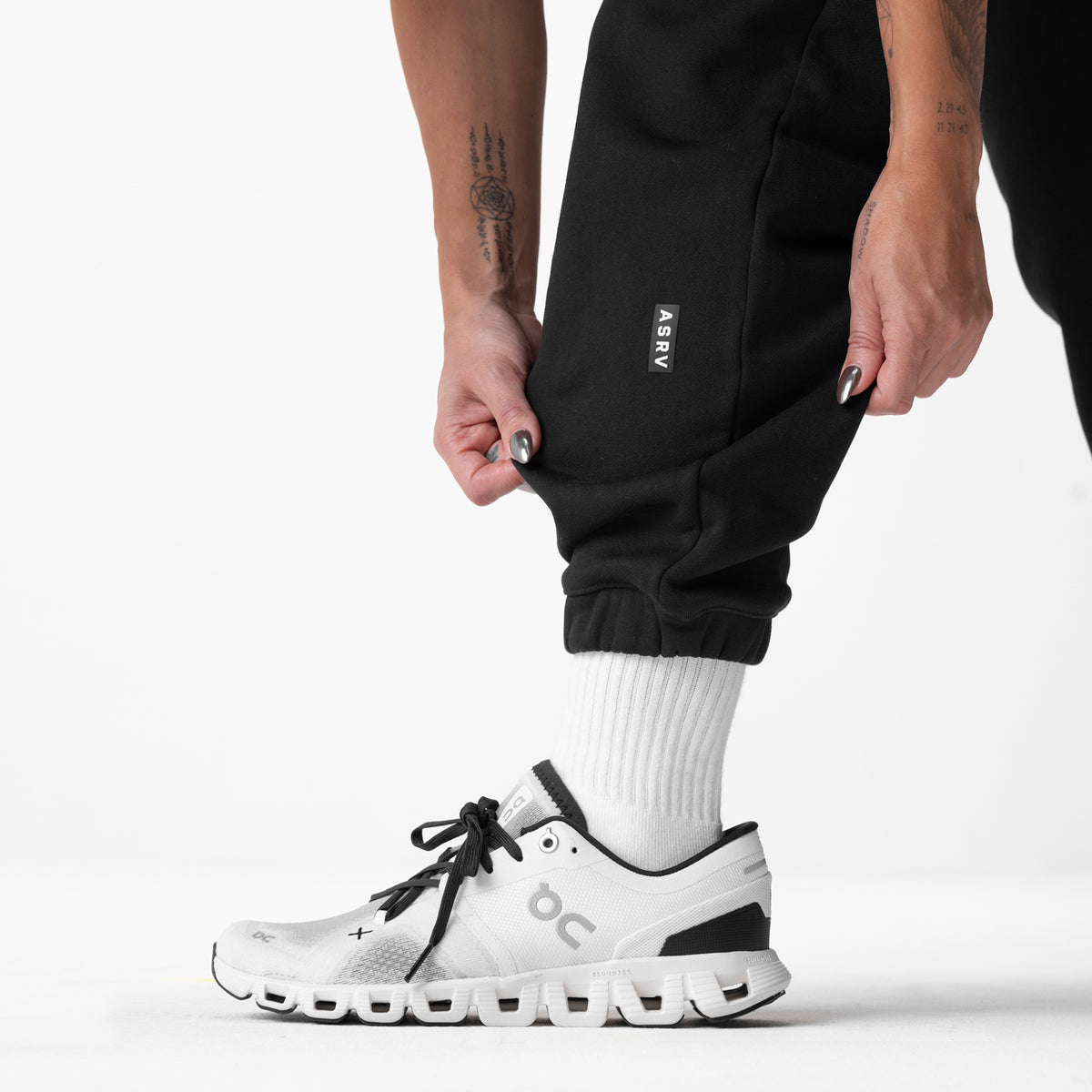 Black ASRV Sorona French-Terry Oversized Jogger worn with white socks and sneakers, side view