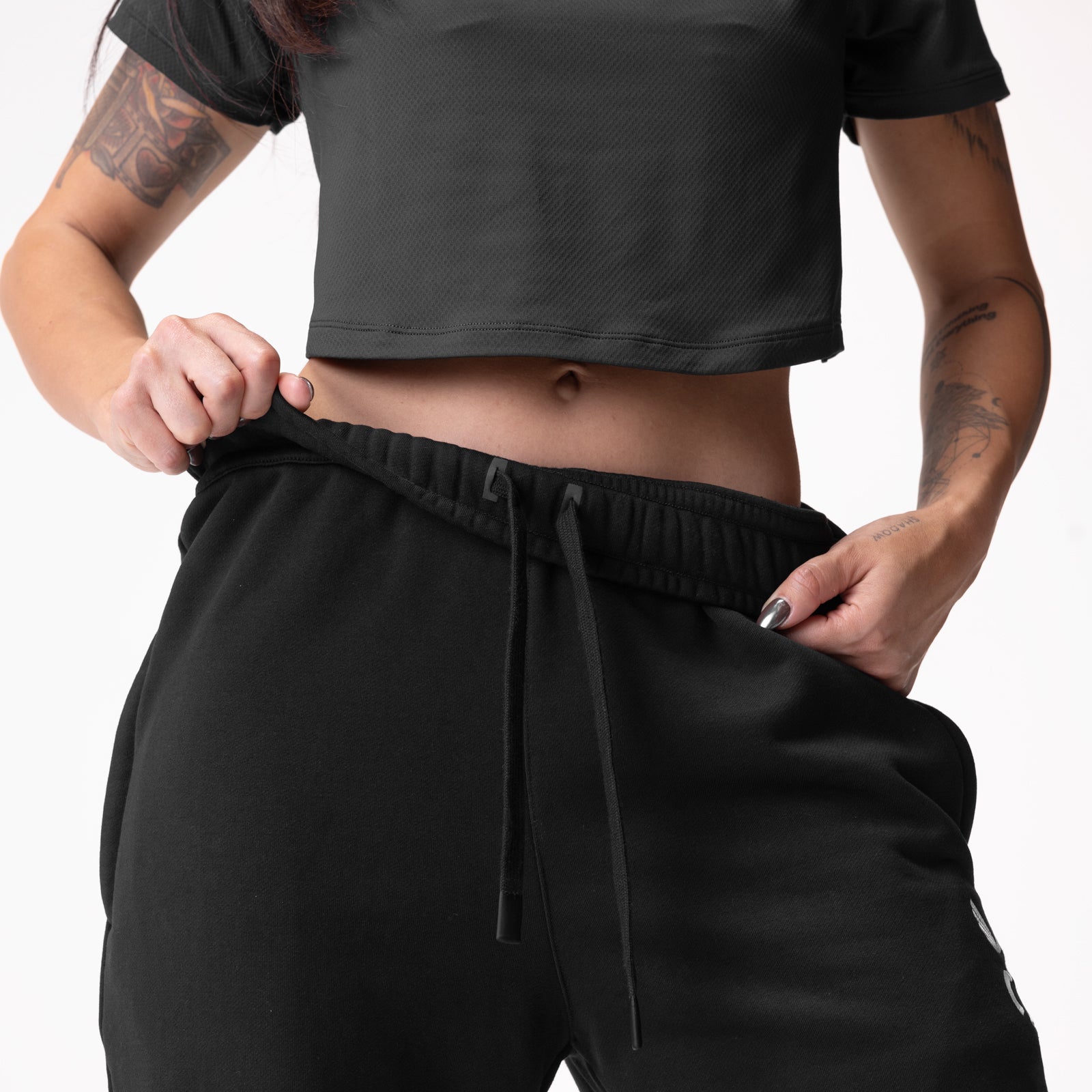 Black oversized jogger worn by model, waist detail view showing drawstring