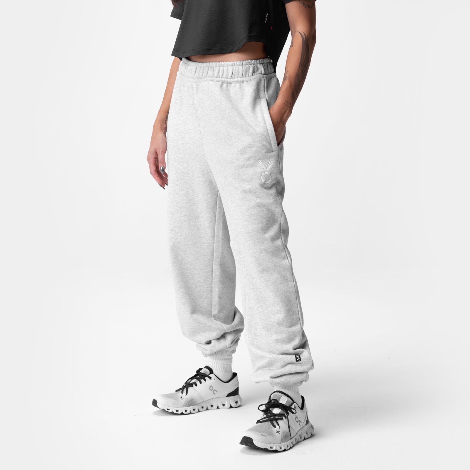 Heather grey oversized jogger worn with white sneakers, side view