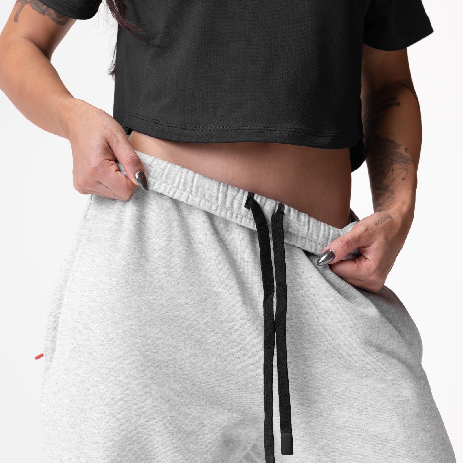 Heather grey French-terry oversized jogger worn by model, showing drawstring and side pocket detail