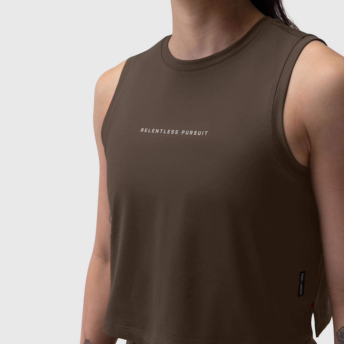 AeroSilver Tank Top in Dark Earth worn by model, front view with 'Relentless Pursuit' text
