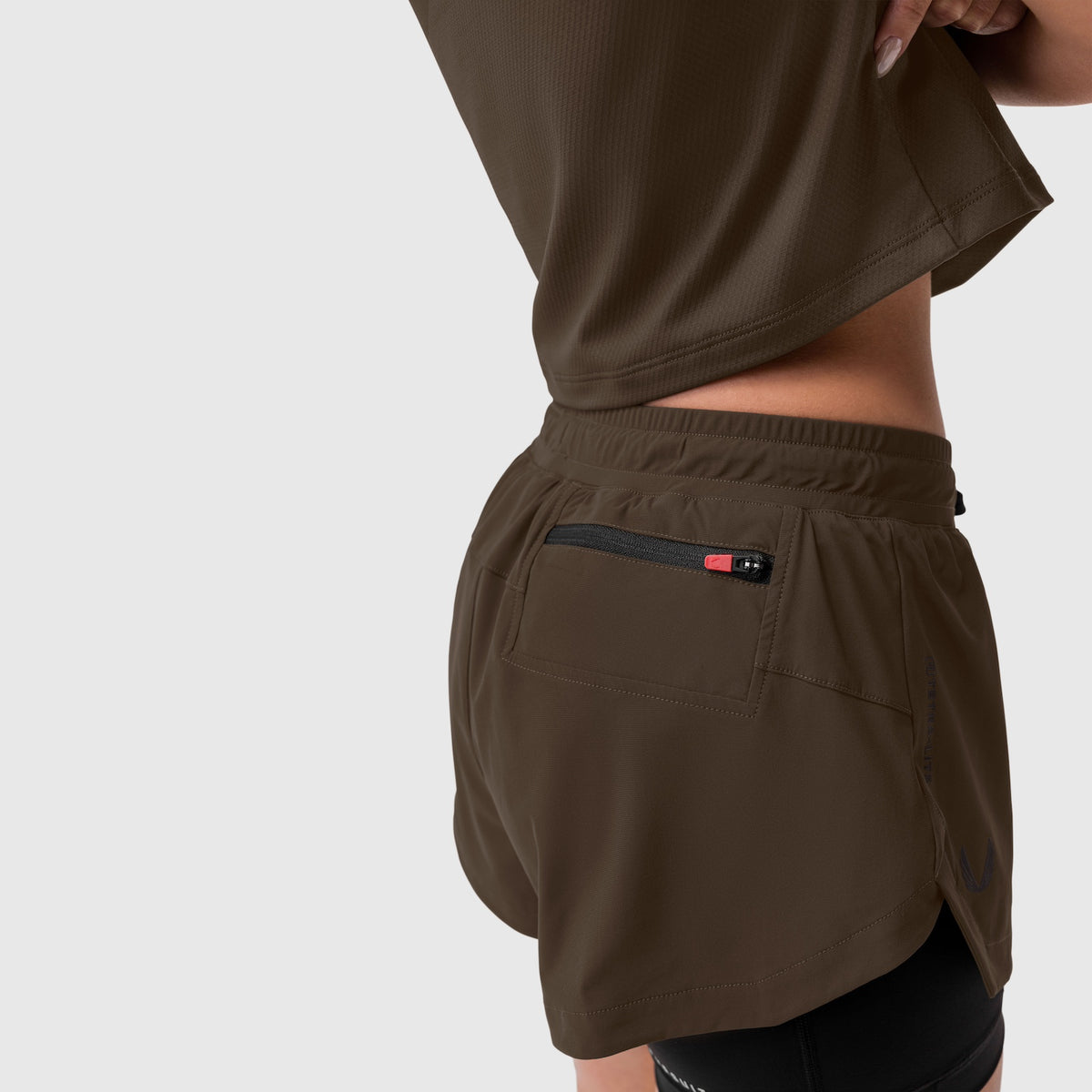 Tetra-Lite Liner Short in Dark Earth worn by model, back view showing rear pocket detail