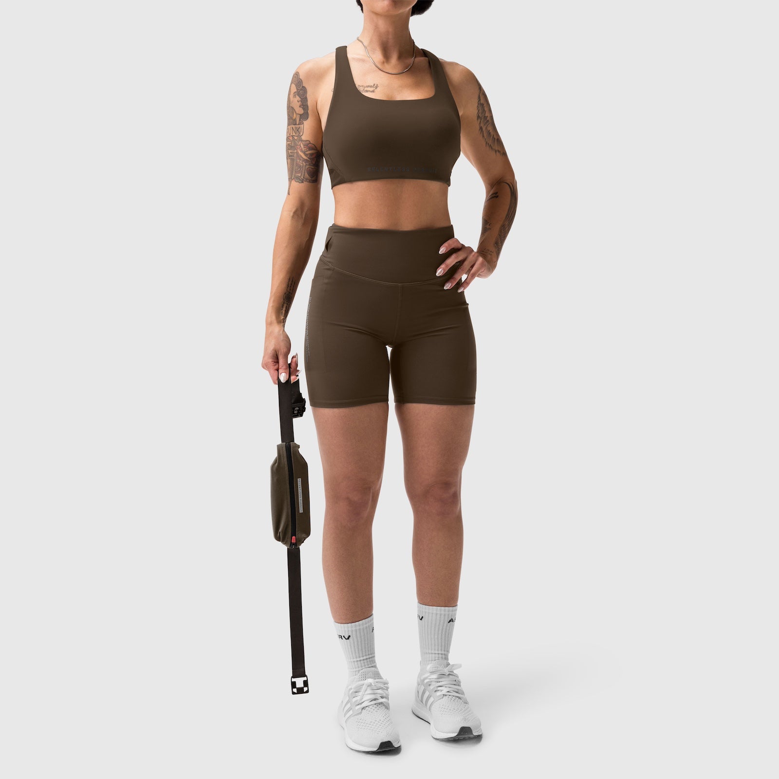 LYCRA® 3-in-1 Biker Short in Dark Earth, worn with sports bra, front pose