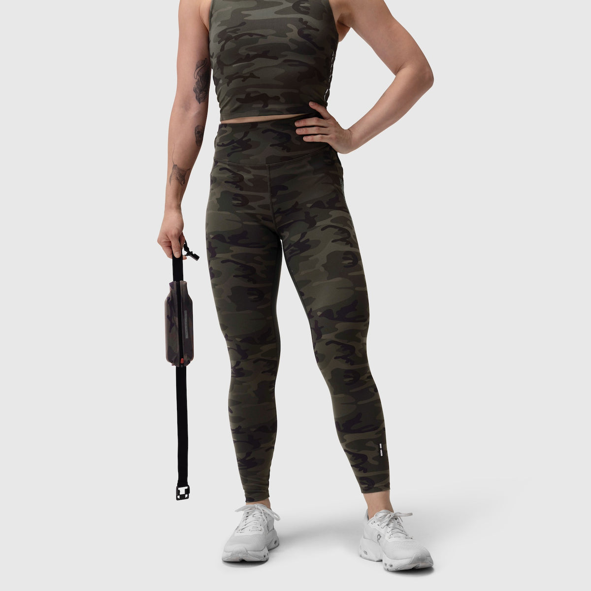 W030 LYCRA® 3-in-1 Legging in dark camo, worn with white sneakers and matching tank top