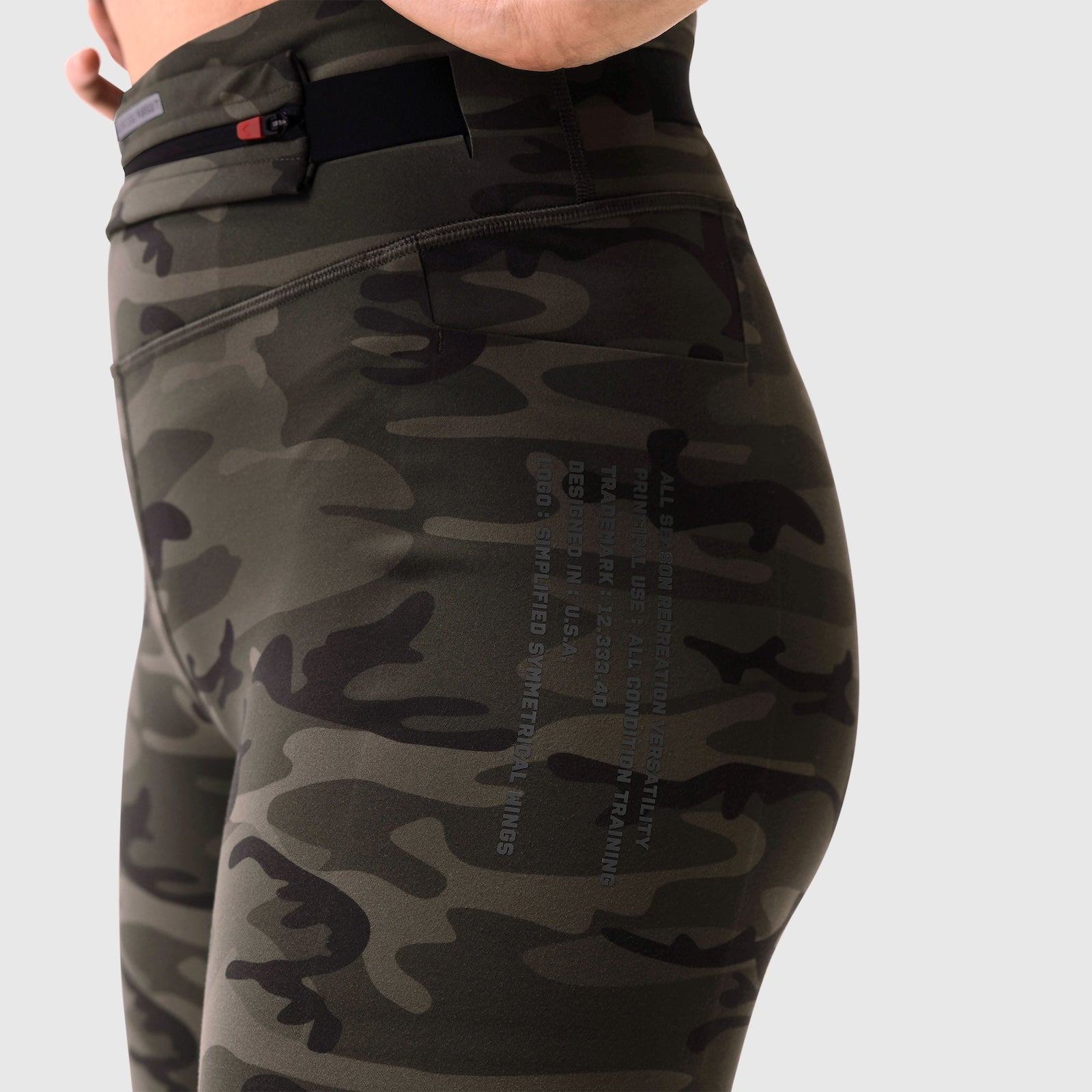 W030 LYCRA® 3-in-1 Legging in Dark Camo, worn on model, side view