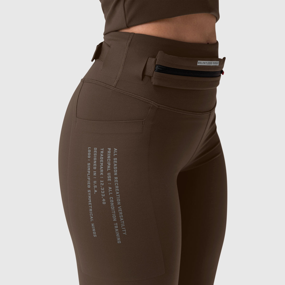 W030 LYCRA® 3-in-1 Legging in dark earth, worn by model, side view
