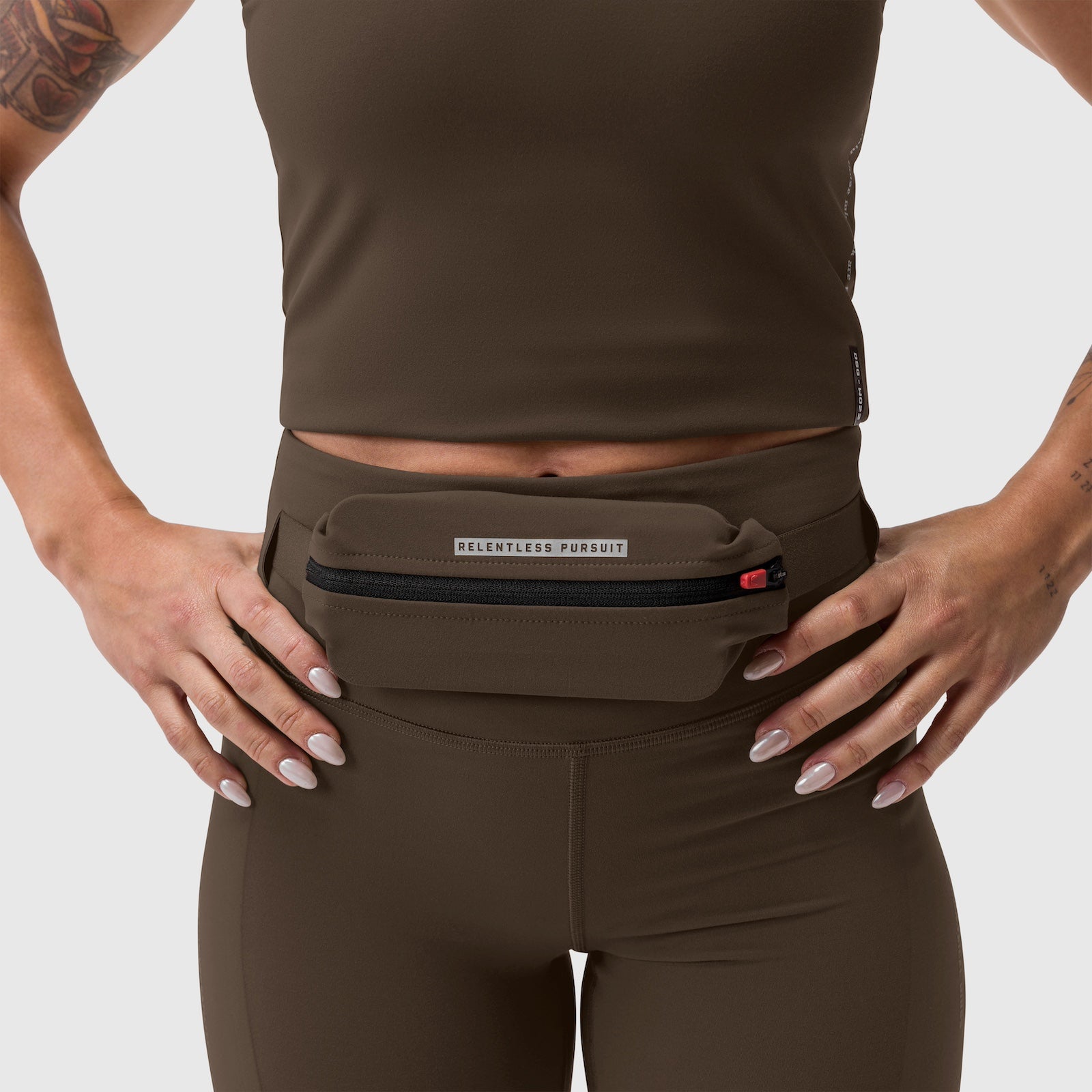 W030 LYCRA® 3-in-1 Legging in Dark Earth, model wearing with waist pouch, front view
