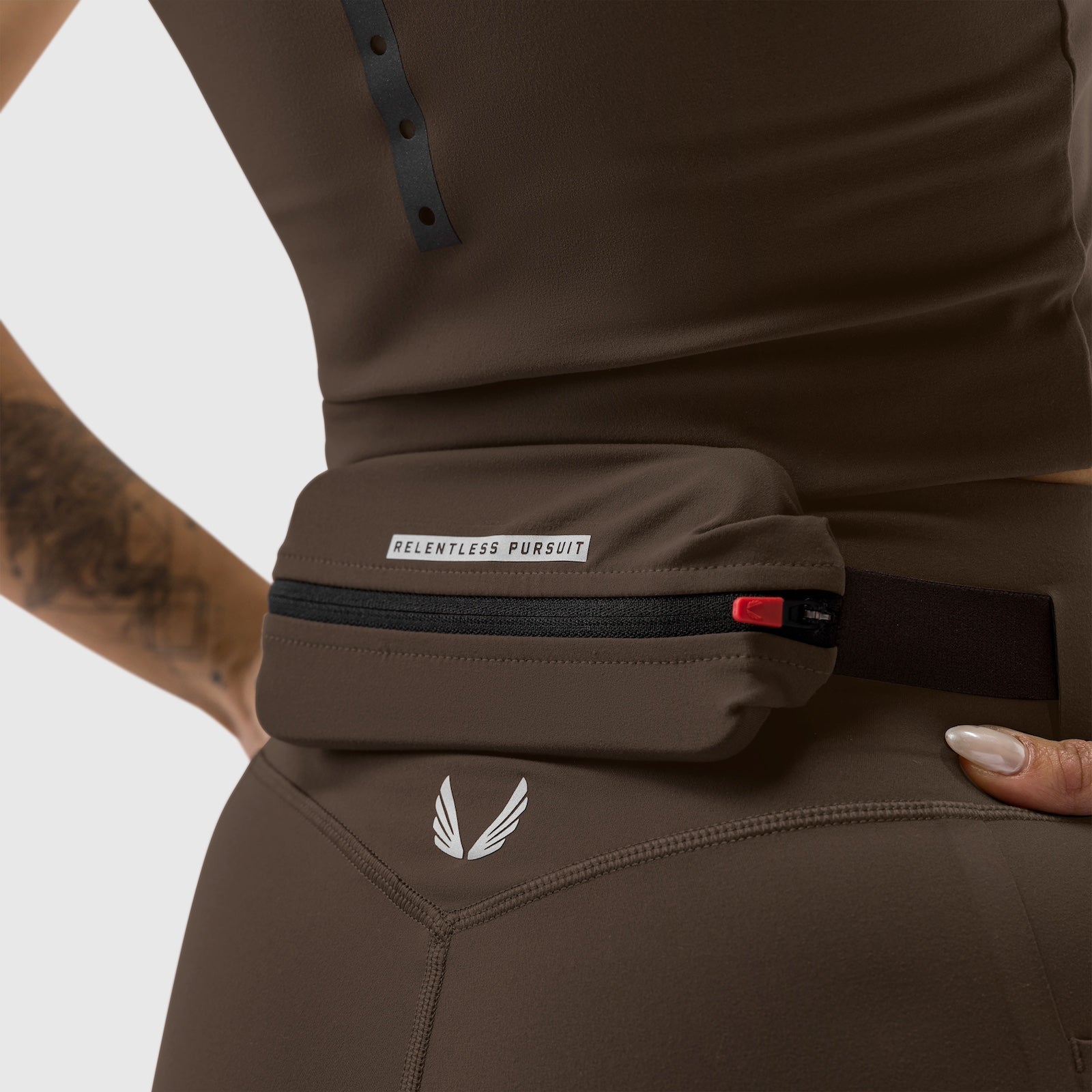 W030 LYCRA® 3-in-1 Legging in Dark Earth worn with matching belt pack, detail view