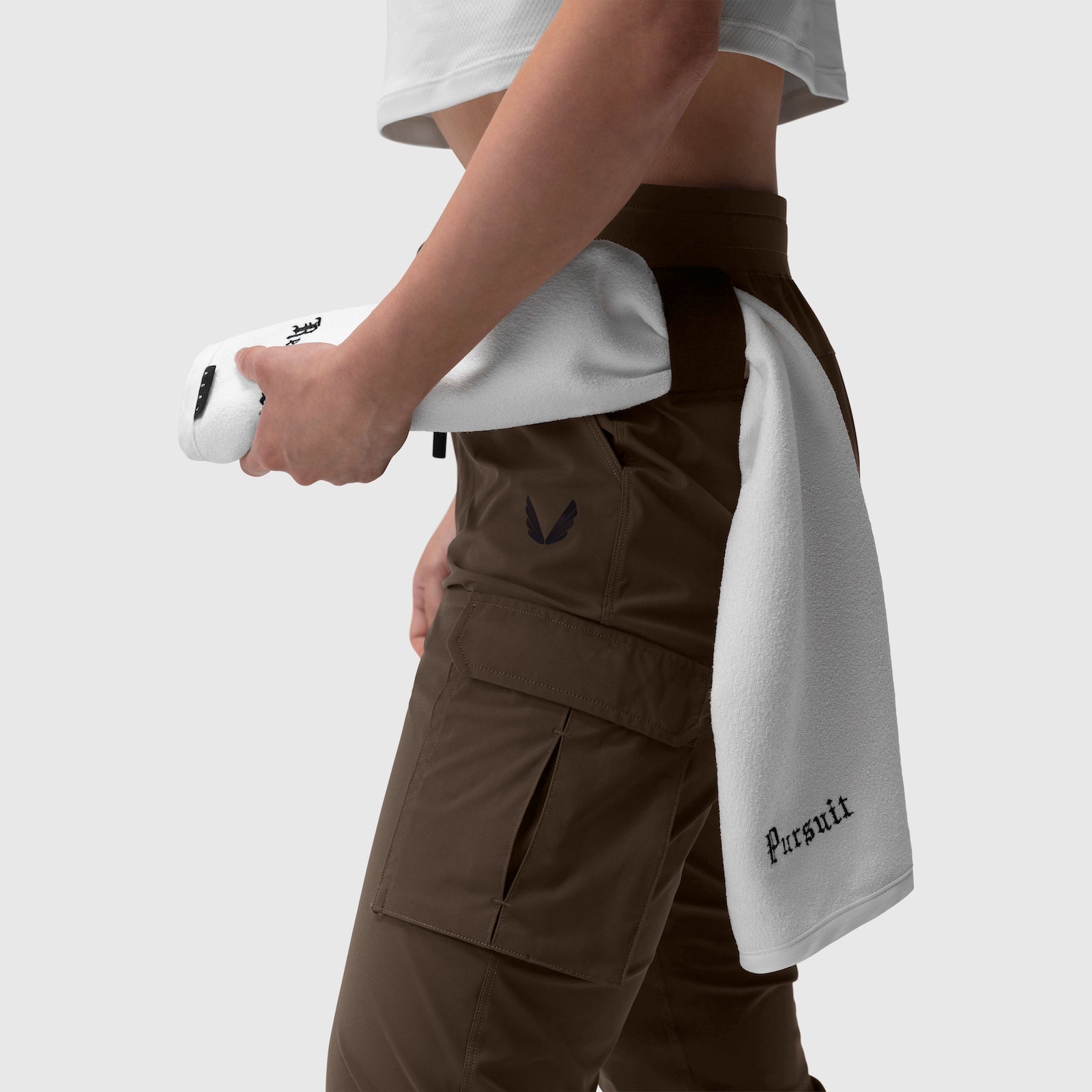 Tetra-Lite Cargo High Rib Jogger in Dark Earth, worn with white towel, side view