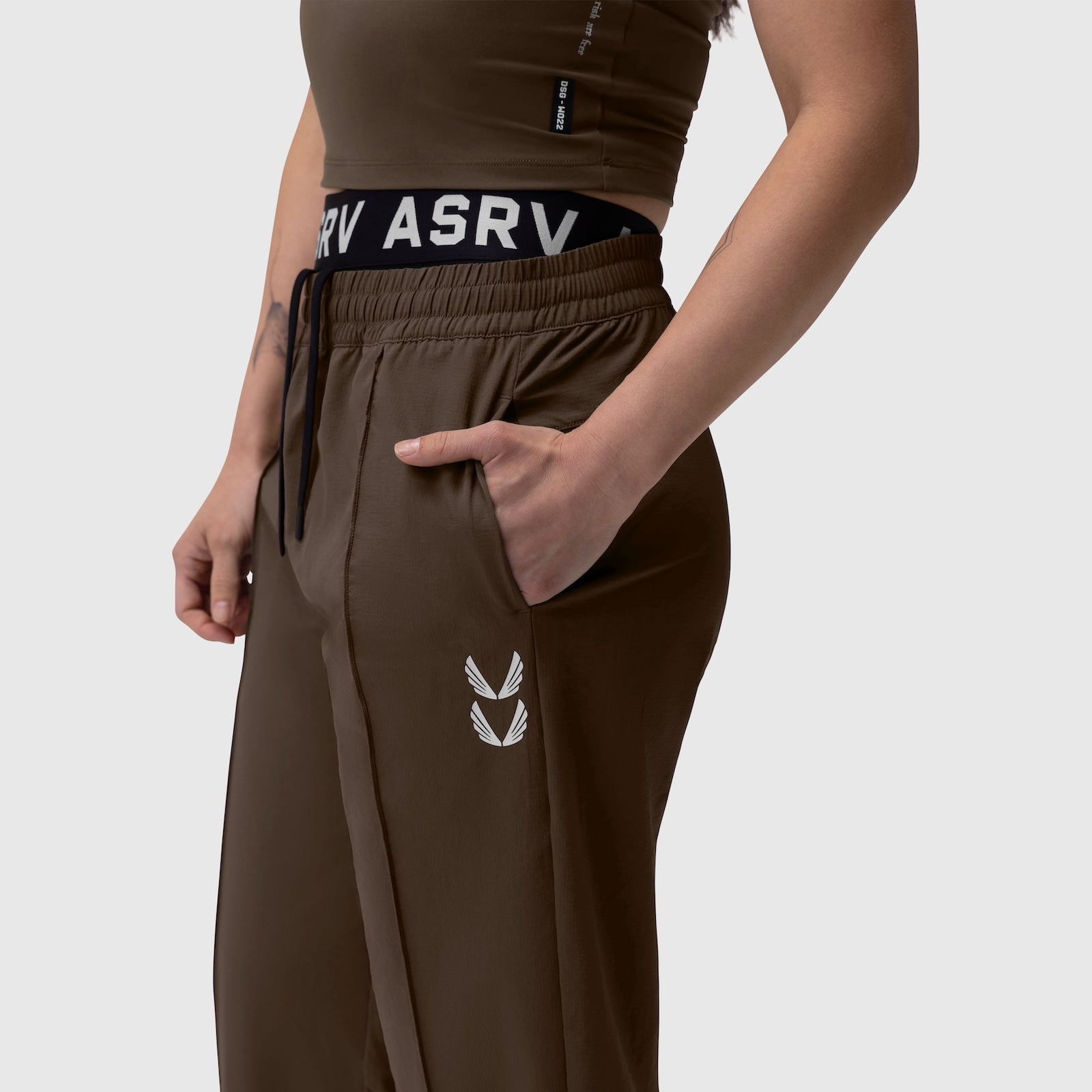 W036 Ripstop Relaxed Track Pant in Dark Earth, worn by model showing side view with hand in pocket