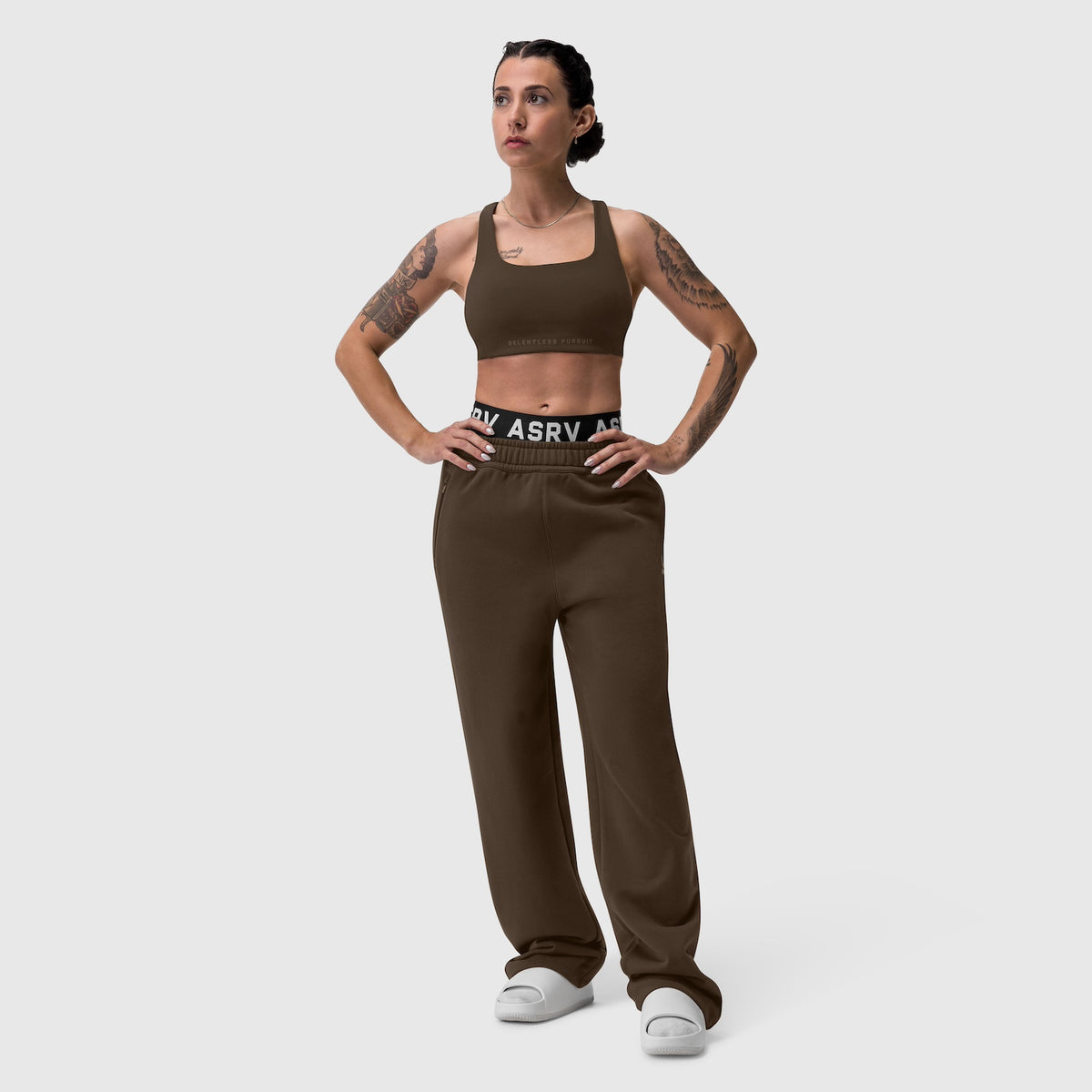 W039 Lycra Hybrid Sports Bra in dark earth, worn with matching joggers, front view