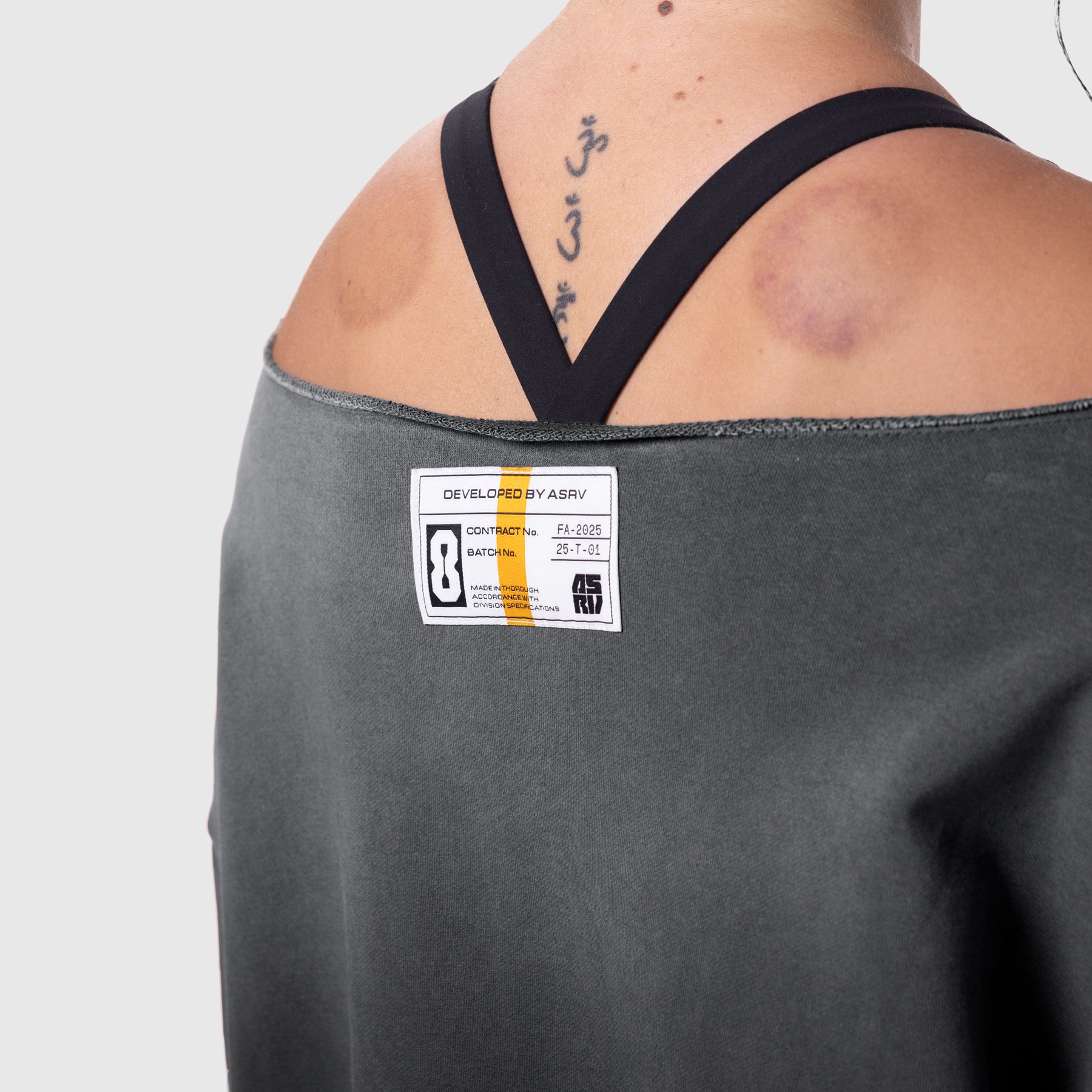 Raw Hem Oversized Crewneck in black sun fade, worn by model showing back view with tattoos and label detail