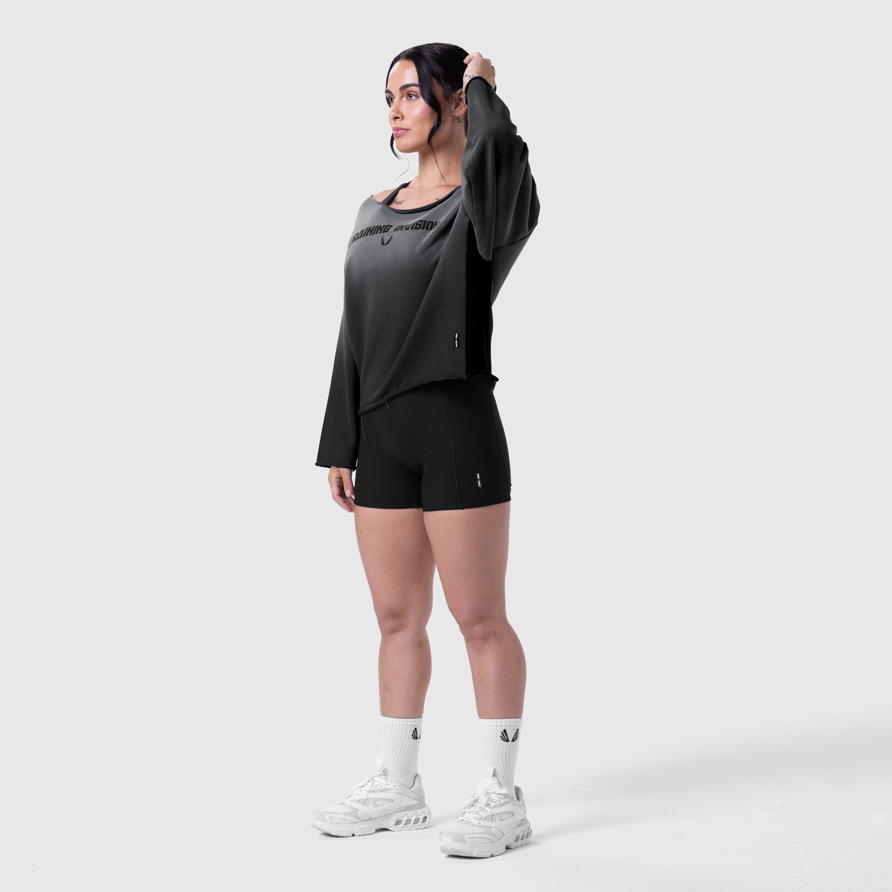 Black sun fade raw hem oversized crewneck worn with black shorts and white sneakers, model standing pose