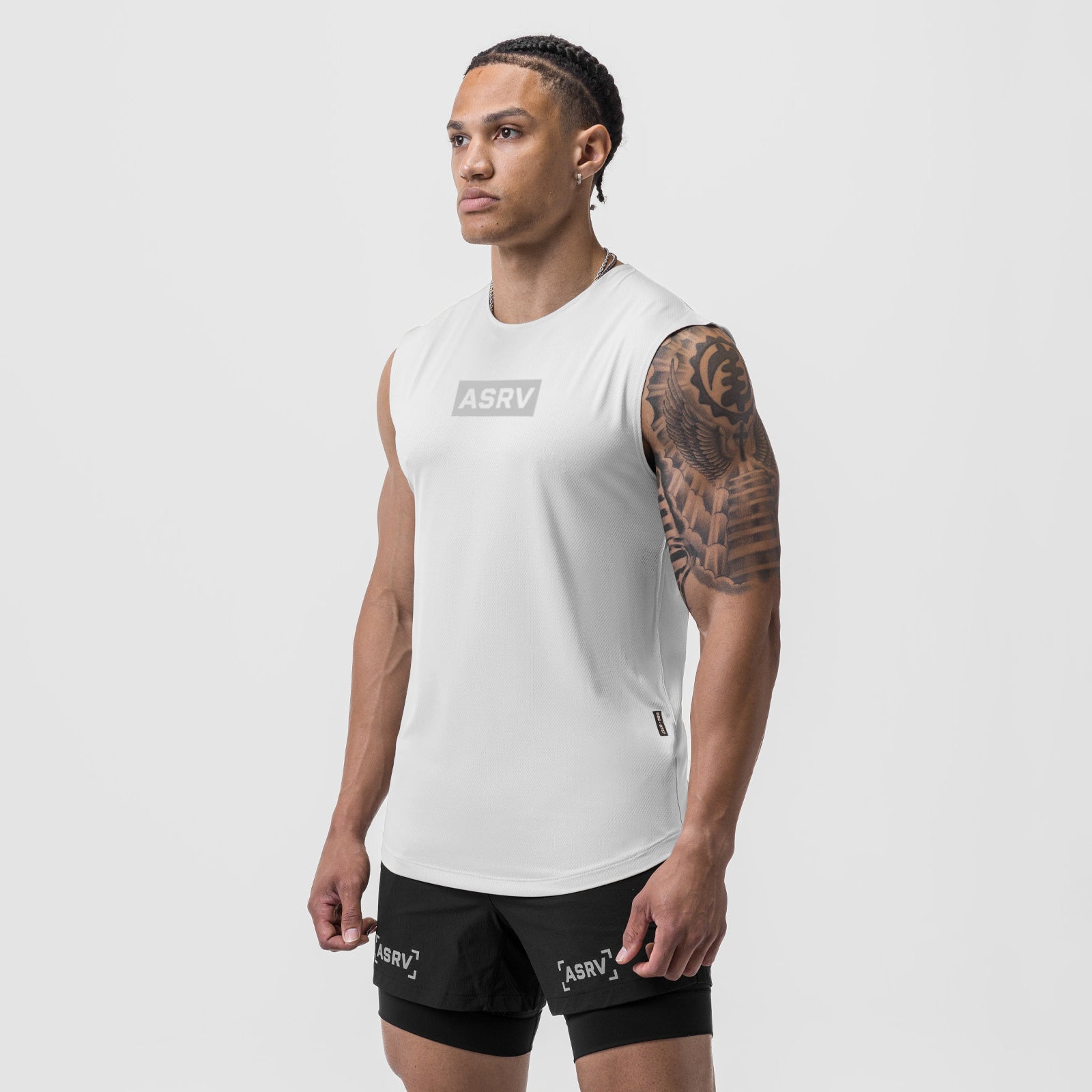 AeroSilver® Cutoff Tank in white with box logo, worn by model with matching black shorts