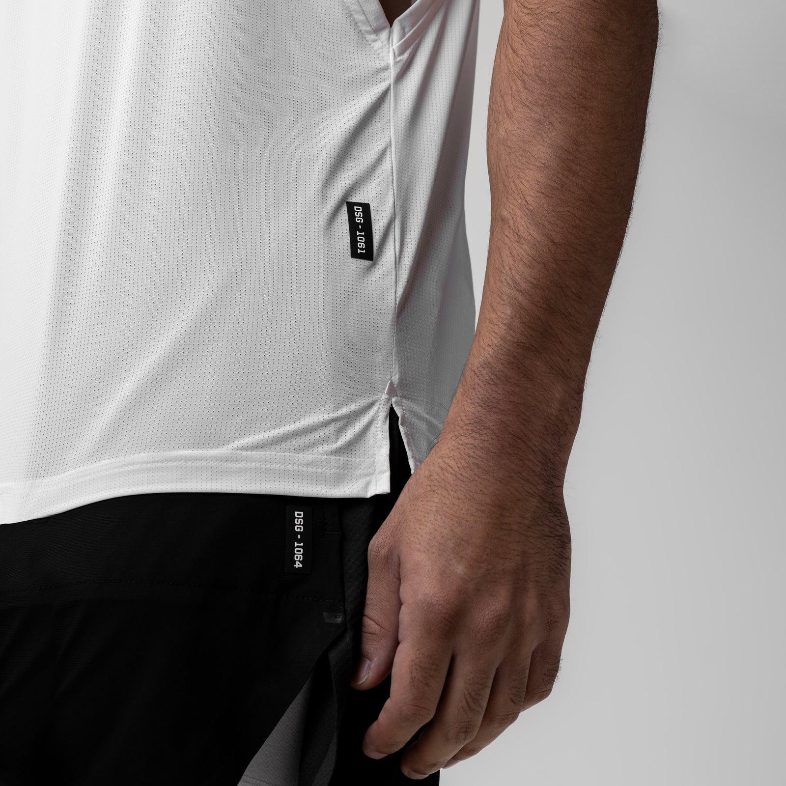White Ice-Skin™ Muscle Tank worn by model, side view showing fabric detail and branding