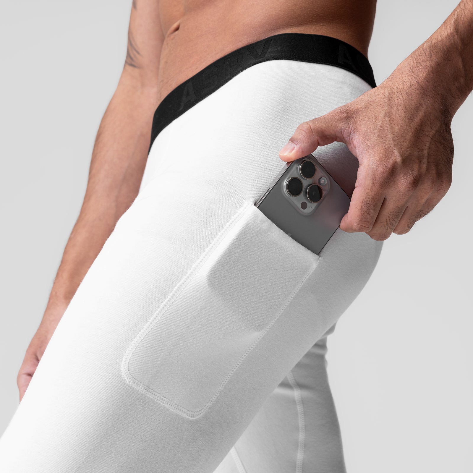 White side pocket legging worn by model, demonstrating phone storage in leg pocket