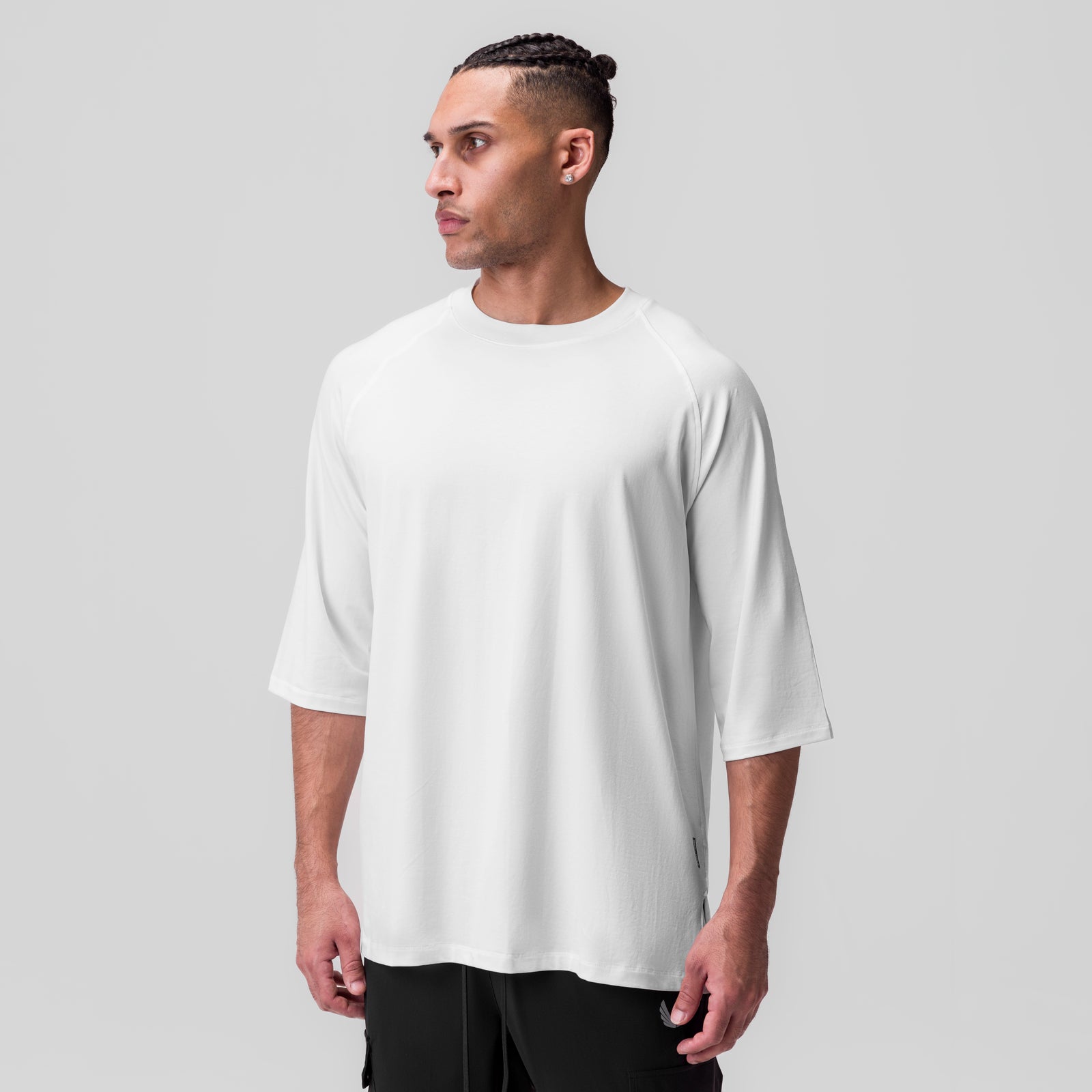 White Supima® 3/4-sleeve oversized tee worn by model, side profile view