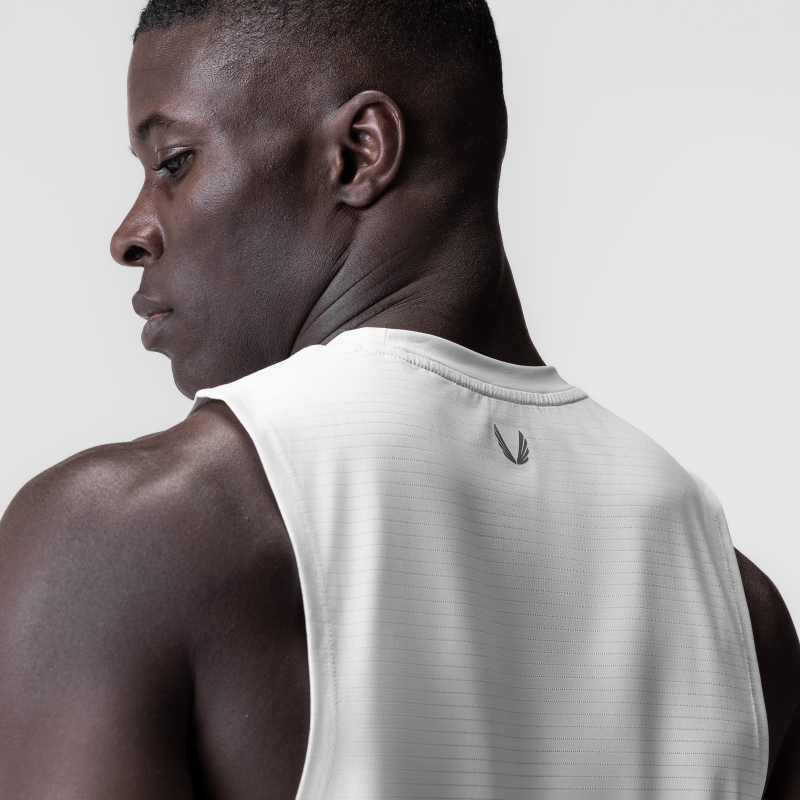 White 3D-Lite® 2.0 Lycra® muscle tank on model, side profile view