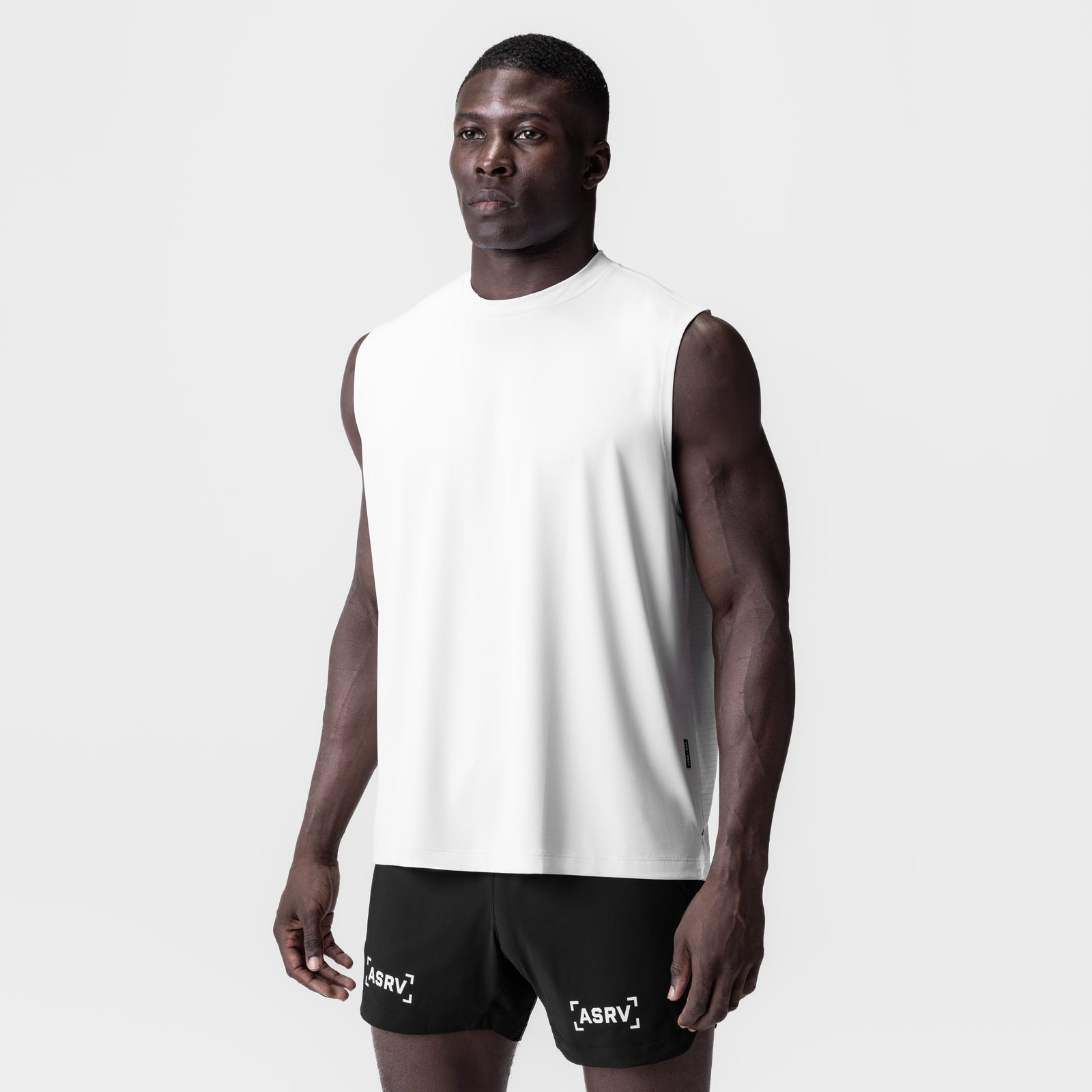 White 3D-Lite® 2.0 Lycra® Relaxed Cutoff tank top and black shorts on model, front view