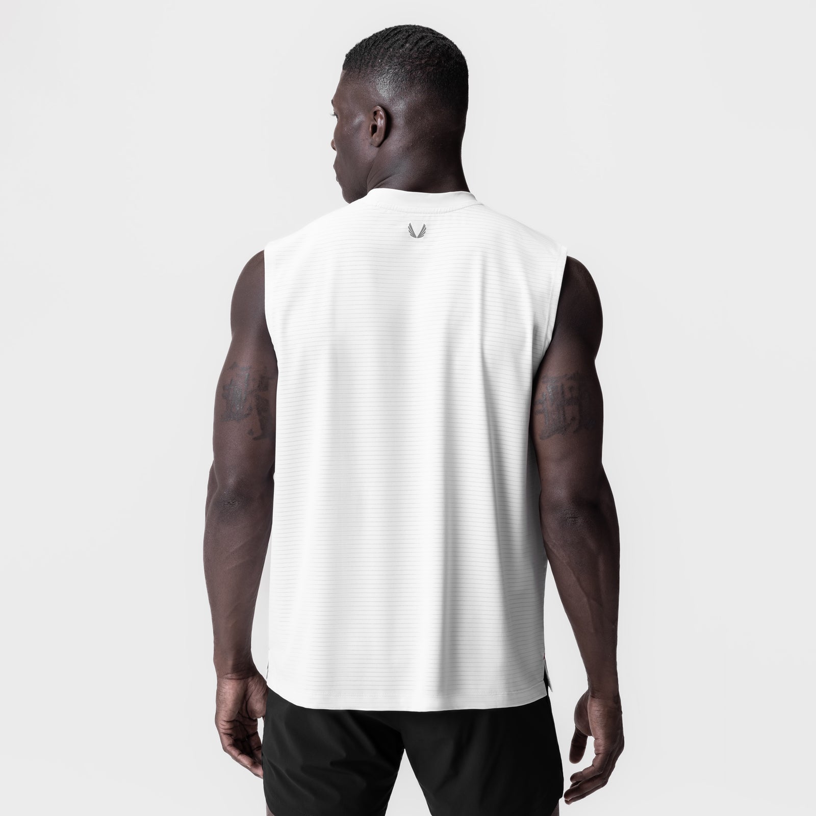 White 3D-Lite® 2.0 Lycra® Relaxed Cutoff tank top worn by model, back view