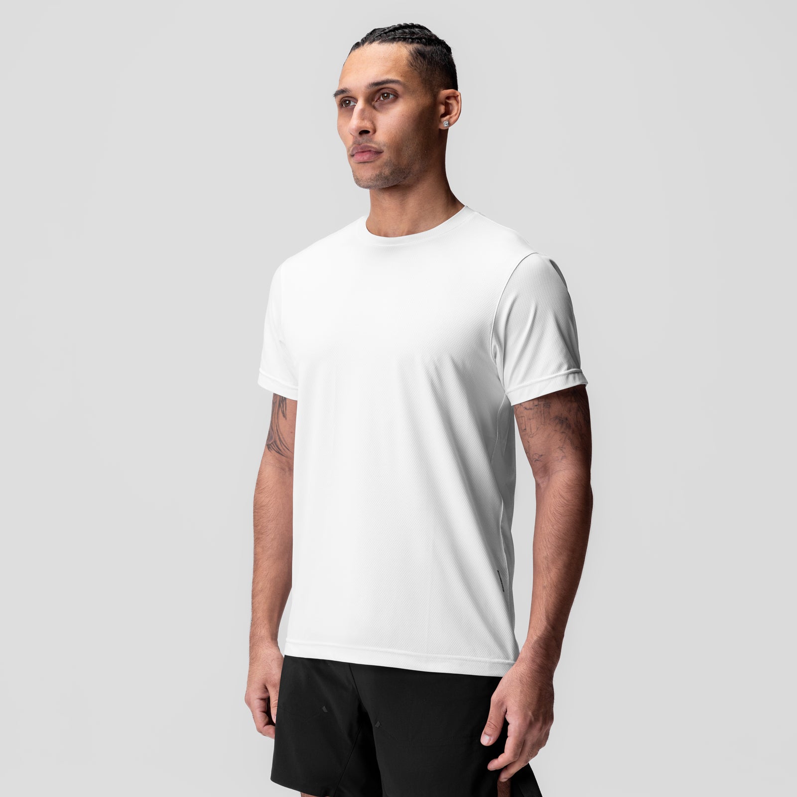 White AeroSilver Essential Tee worn by model, front three-quarter view