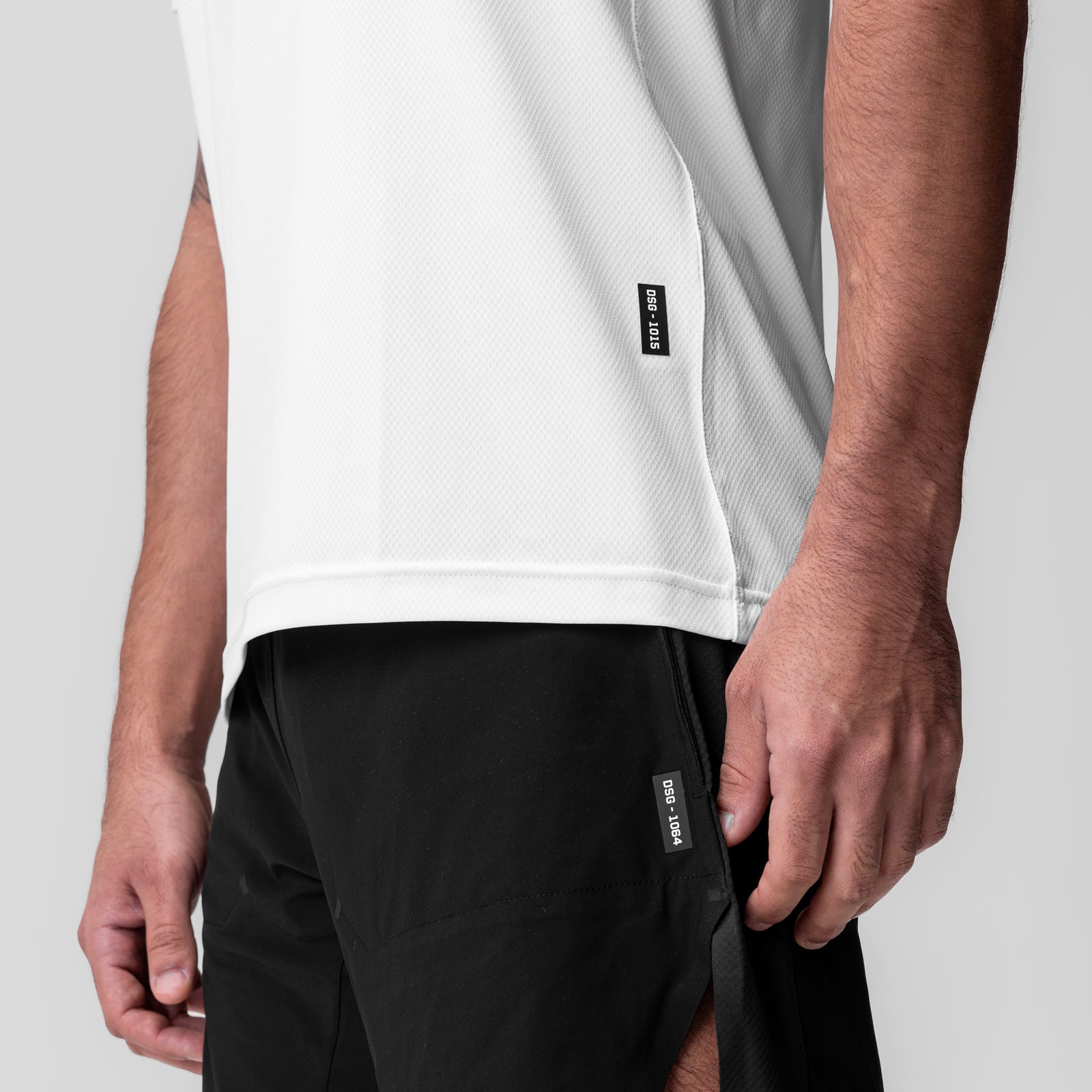 White AeroSilver Essential Tee worn with black shorts, side view on model