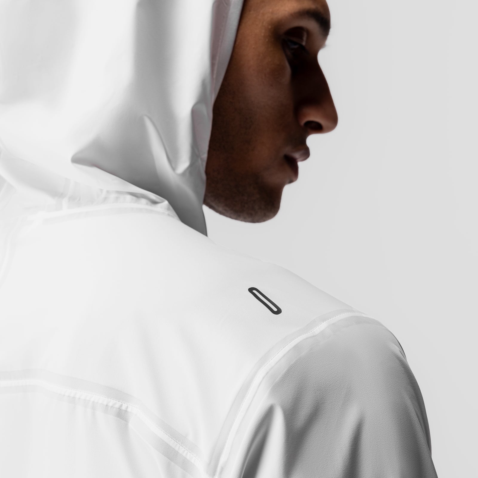 White Aerotex Lightweight Windbreaker worn by model in profile view