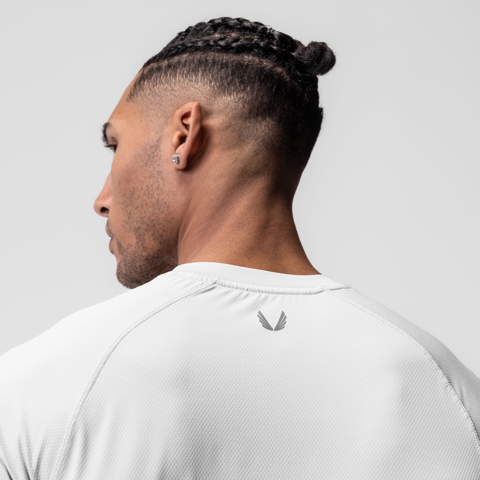 White AeroSilver Established Tee worn by model, back view showing logo