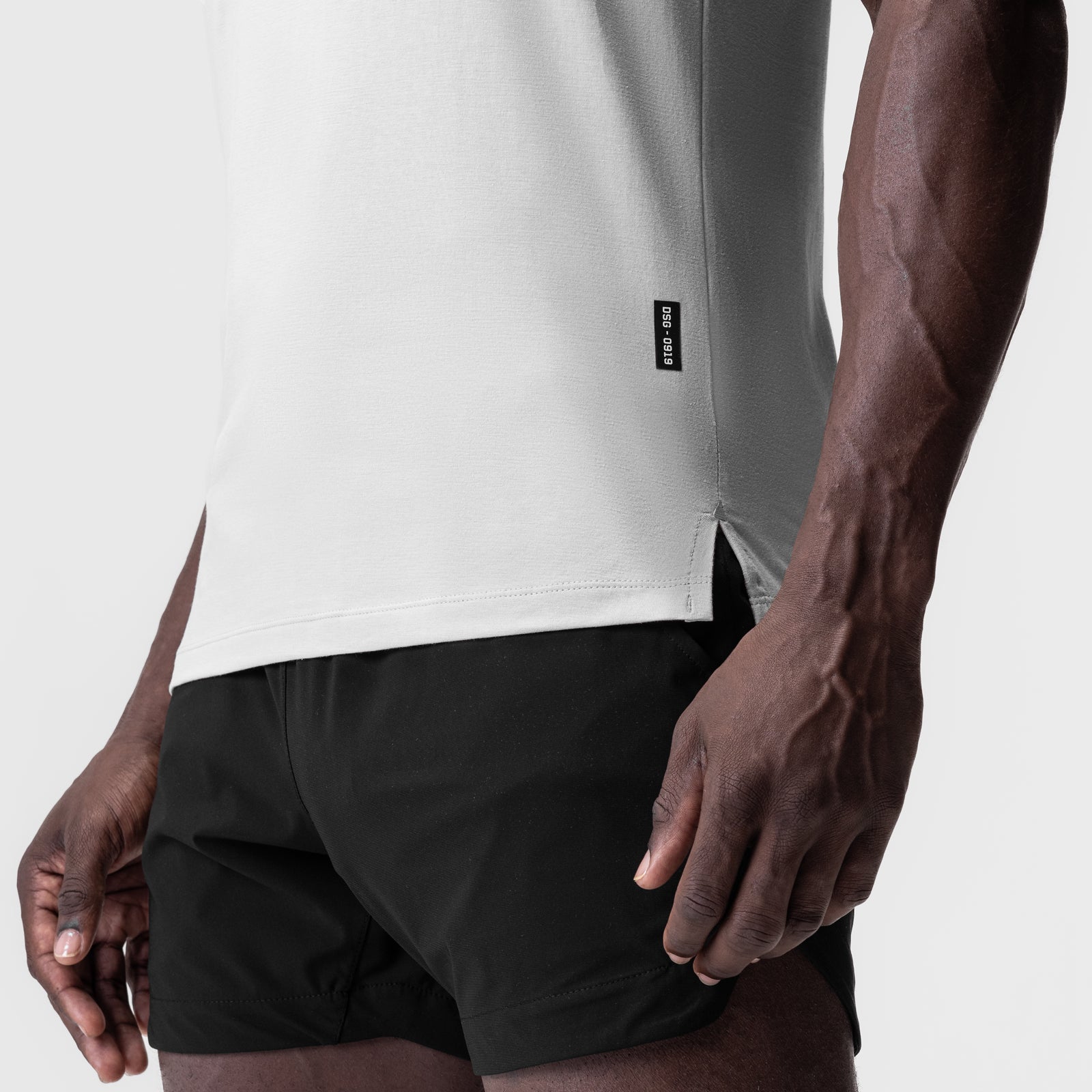 White Supima Fitted Tee worn with black shorts, side view on model