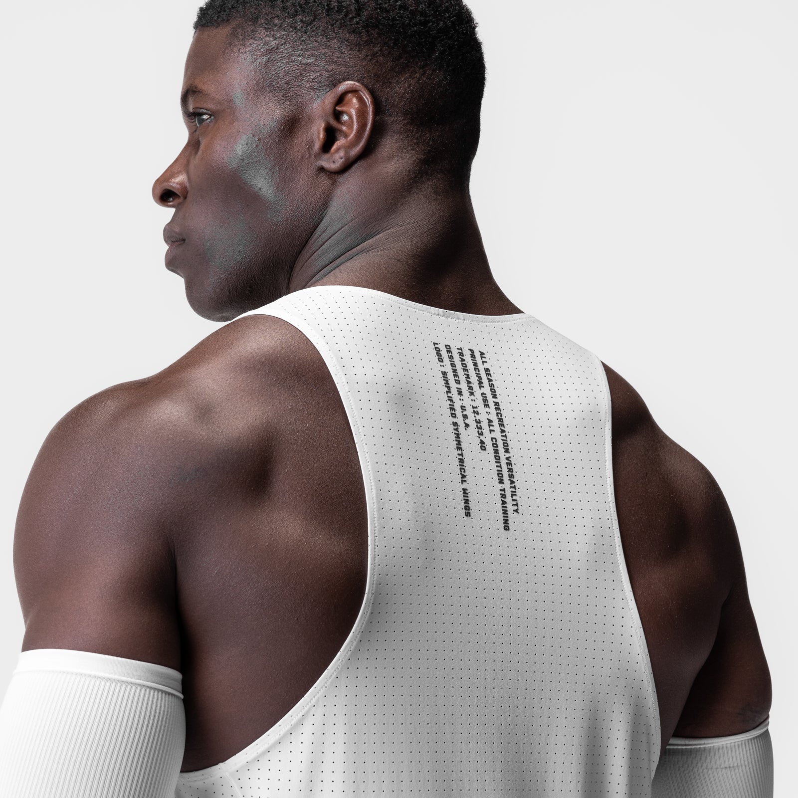 Laser-Vent™ Singlet Tank in white, worn by model shown from back view