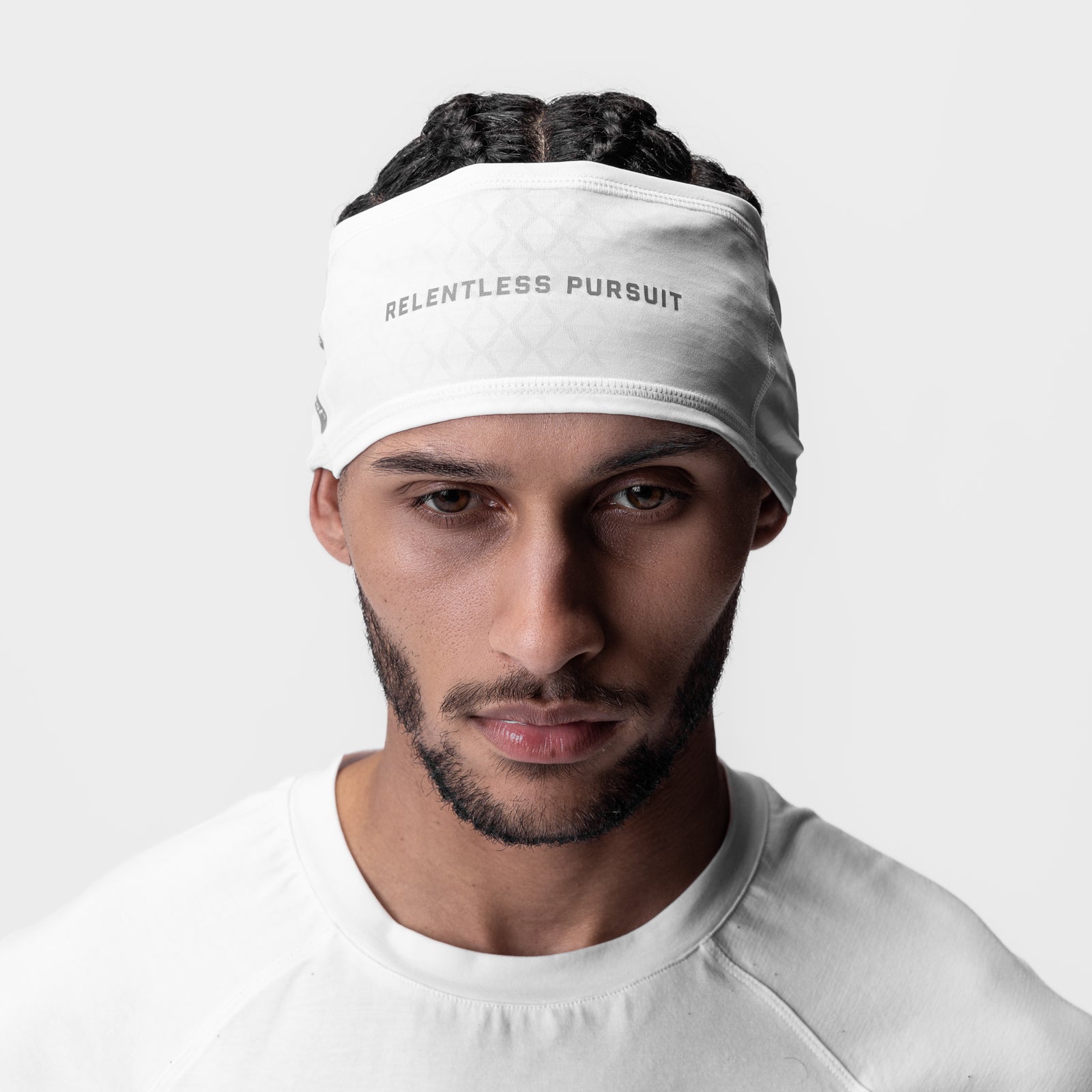 ASRV Outlast Phase Change Headband in white with 'Relentless Pursuit' text, worn by model