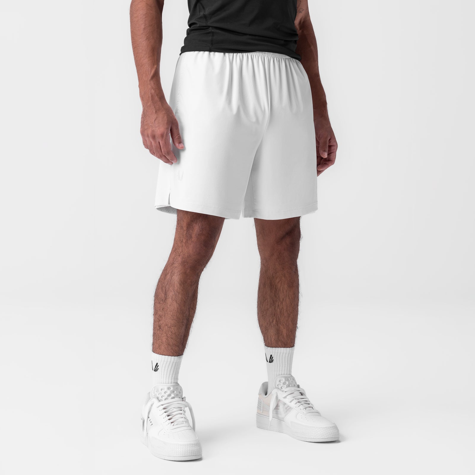 Reversible 2-in-1 shorts in white, modeled on male figure with white sneakers and socks