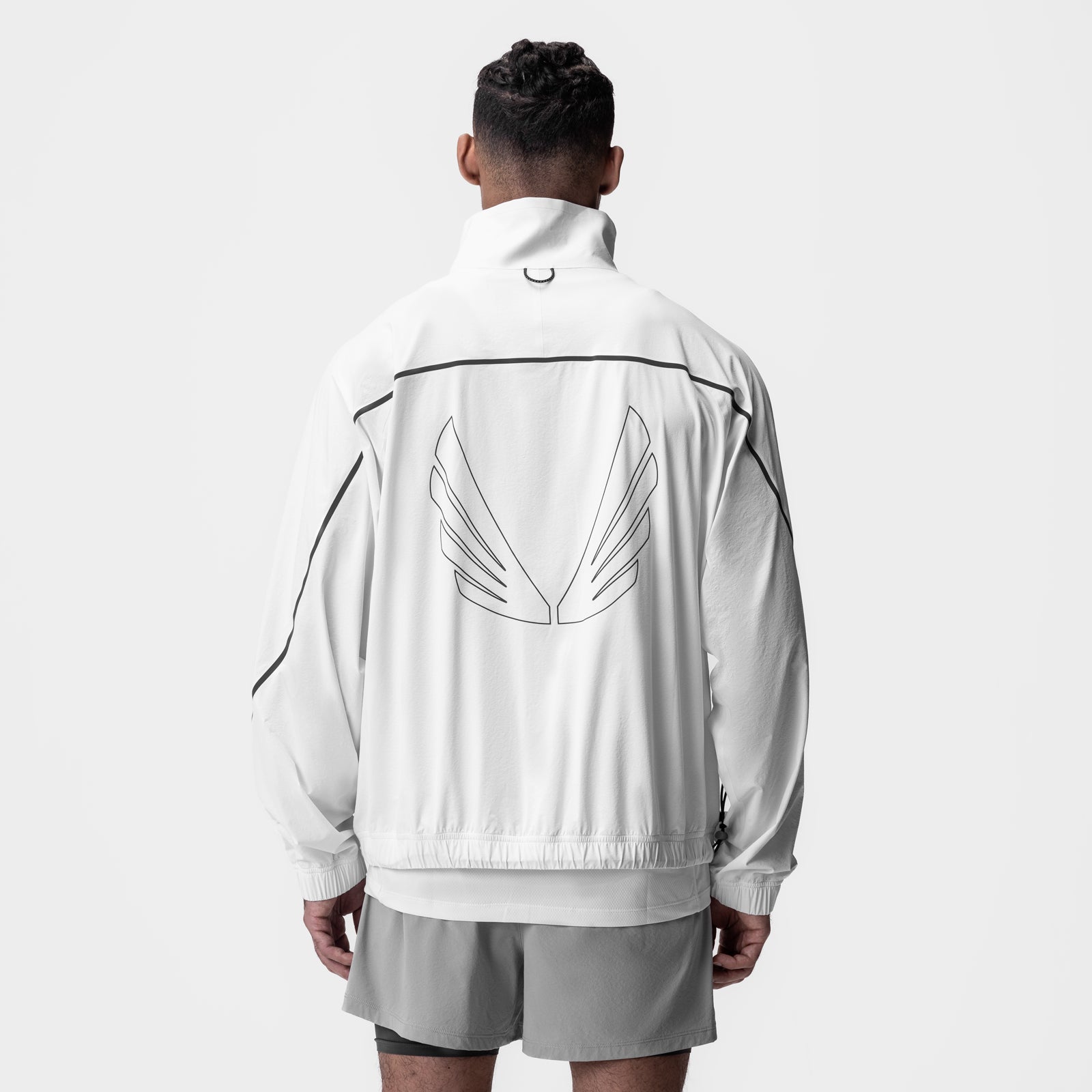 Aerotex™ Track Jacket in white with black trim, worn by model from back view showing wing graphic