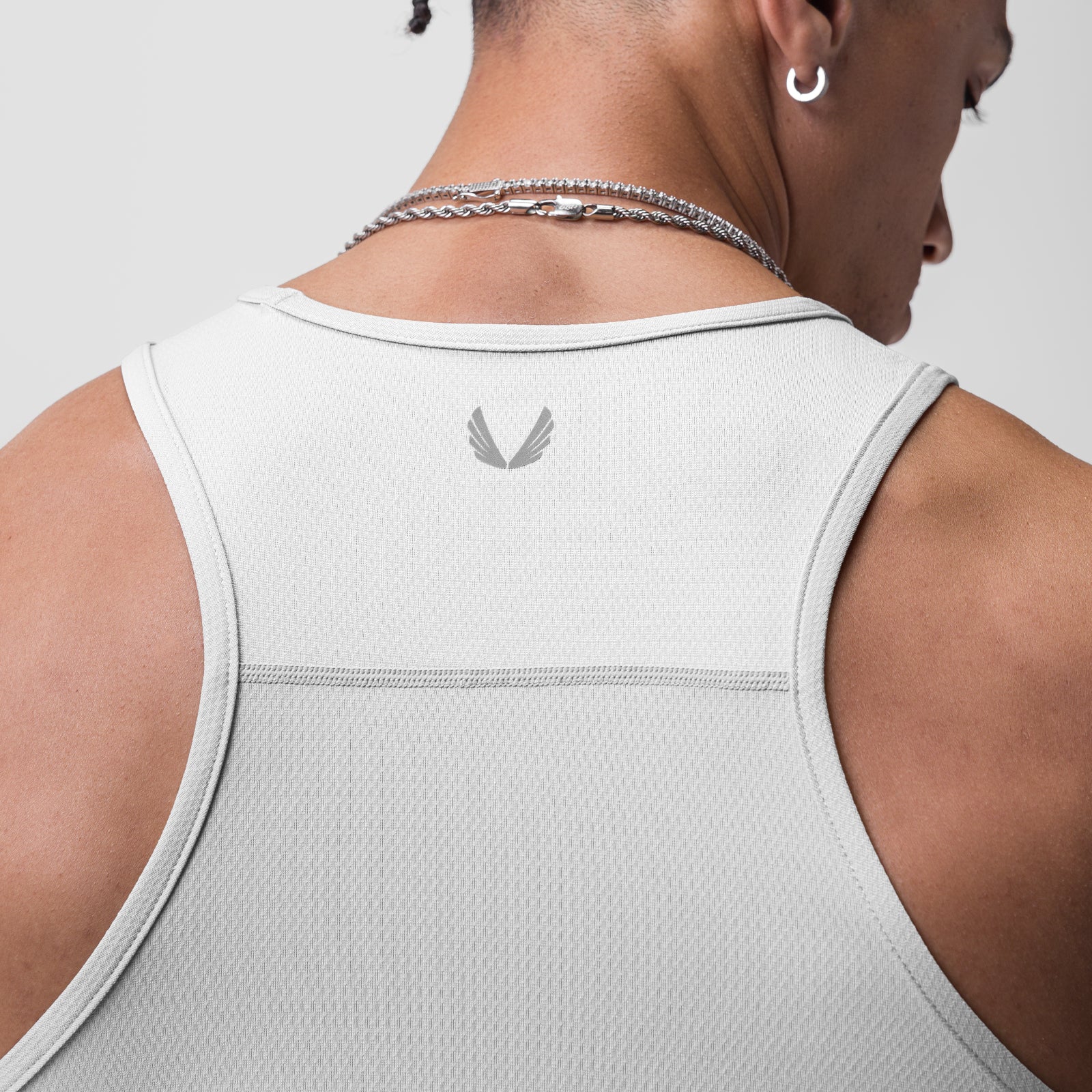 AeroSilver Training Singlet in white, worn by model showing back view with brand logo