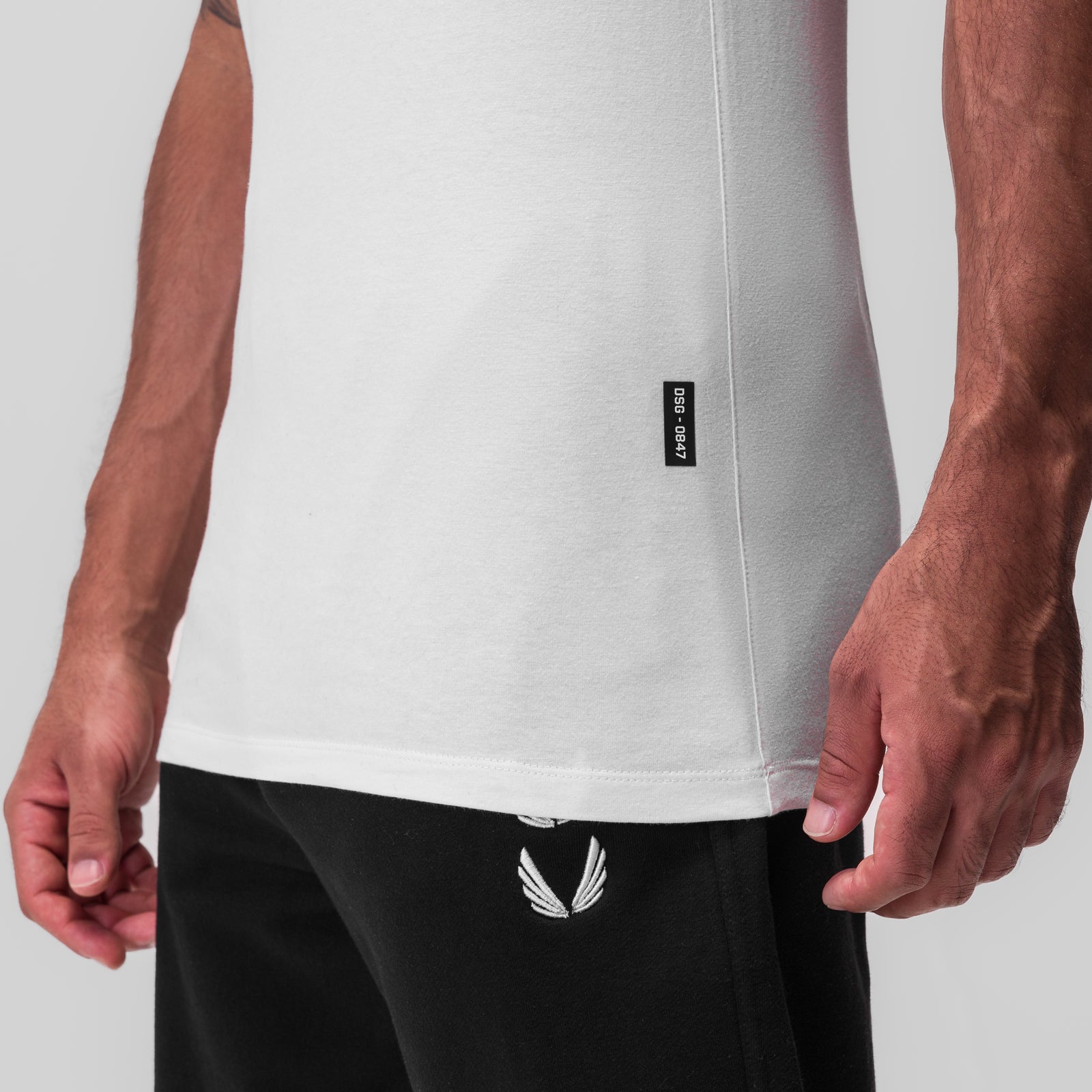 CottonPlus Standard Slim Tank in white worn by male model, front view detail