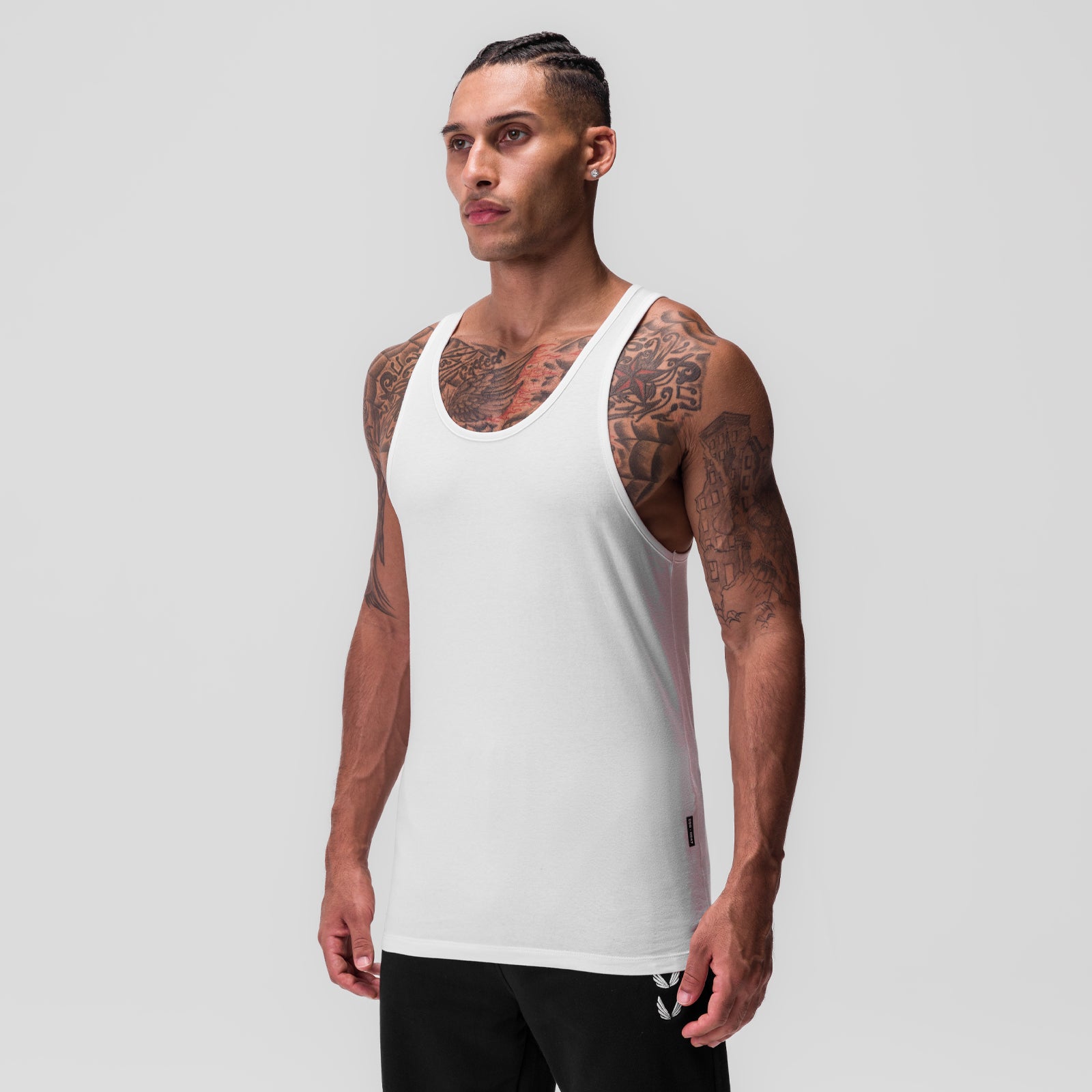 CottonPlus Standard Slim Tank in white, worn by model standing against neutral background