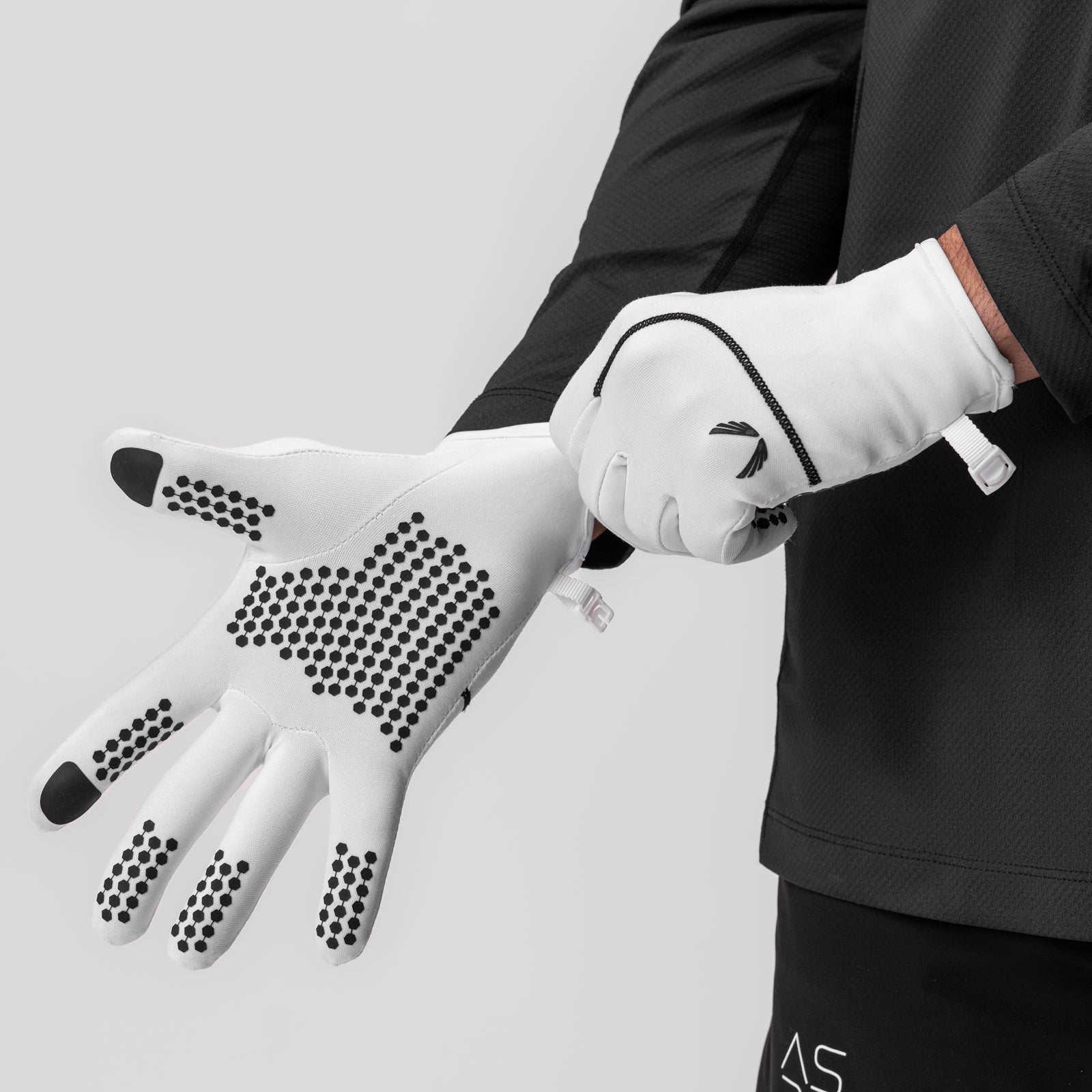 Aeroheat® Lightweight Gloves in white with grip pattern, worn on model's hand