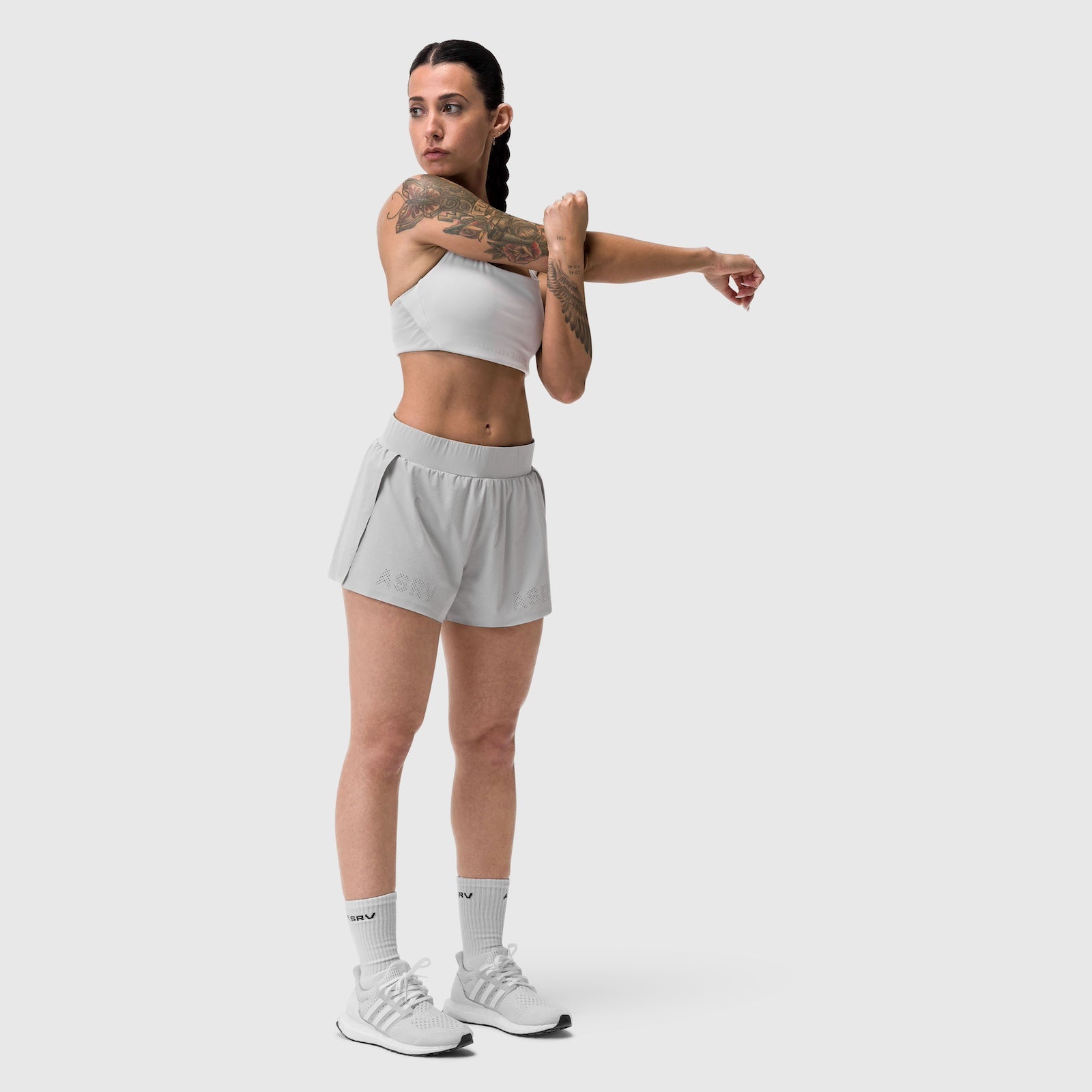 W039 Lycra Hybrid Sports Bra in slate grey, model demonstrating shoulder stretch