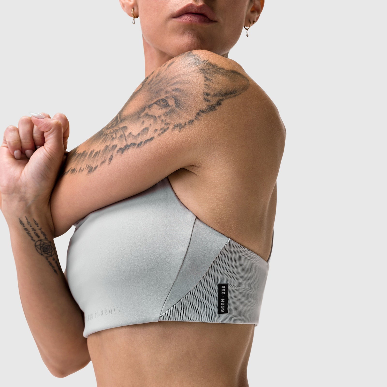 W039 Lycra Hybrid Sports Bra in slate grey, worn by model posing against white background