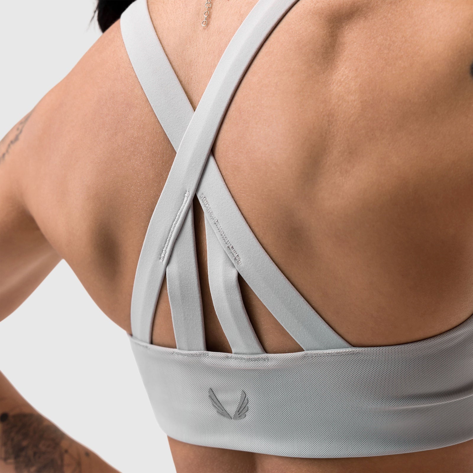 Slate grey Lycra hybrid sports bra on model, back view showing cross-strap design