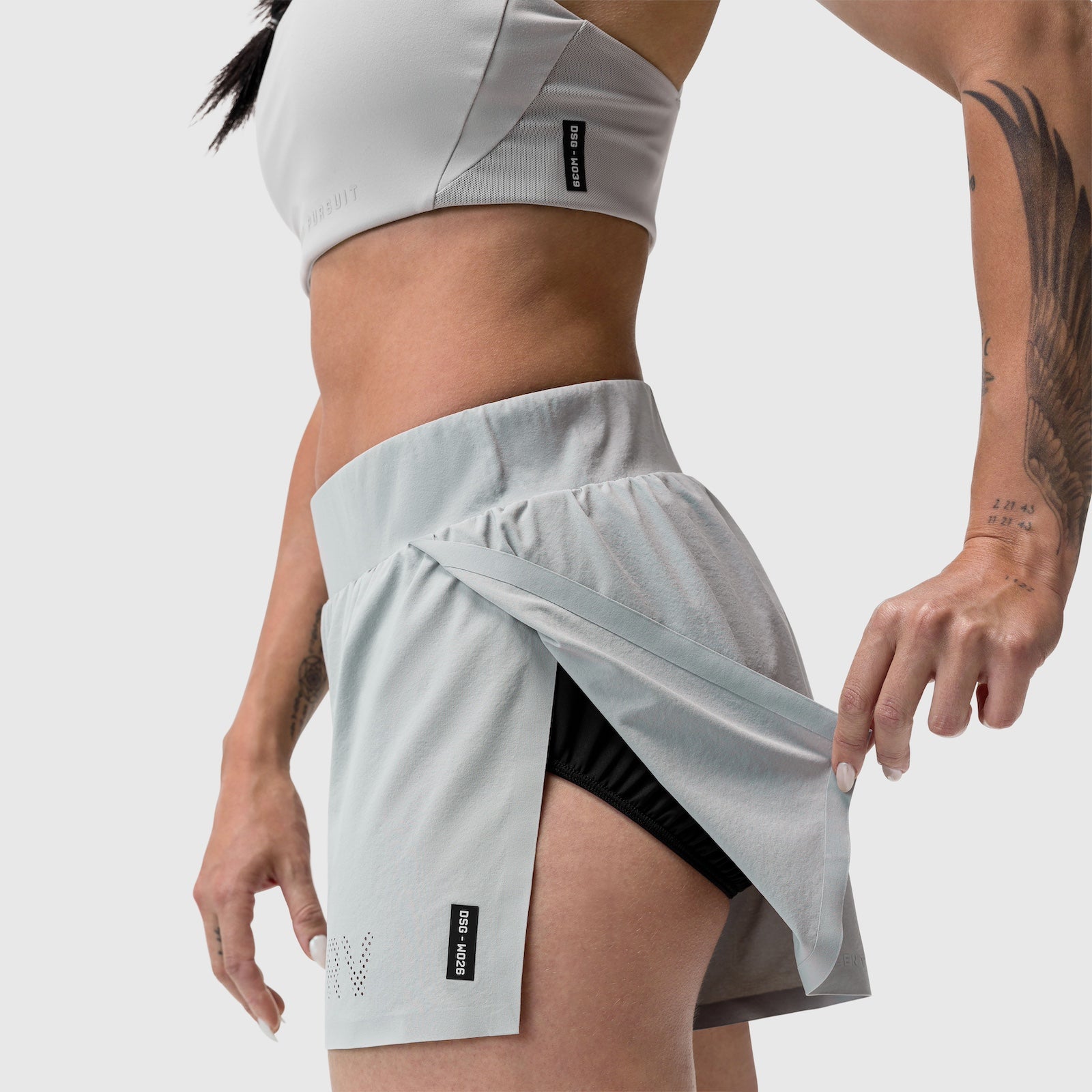 Aerotex Side Split Run Short in slate grey, worn by model showing side split detail and black liner shorts