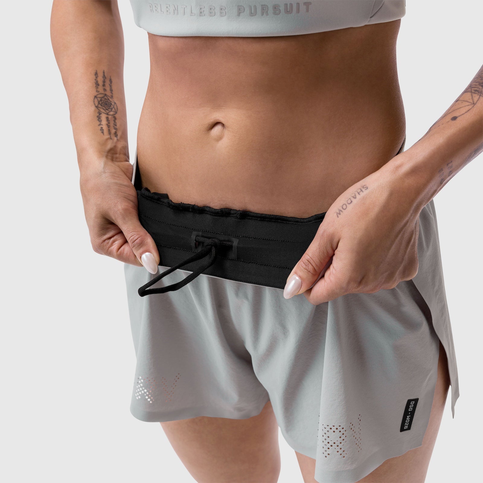 Aerotex™ Side Split Run Short in Slate Grey, model wearing and adjusting waistband
