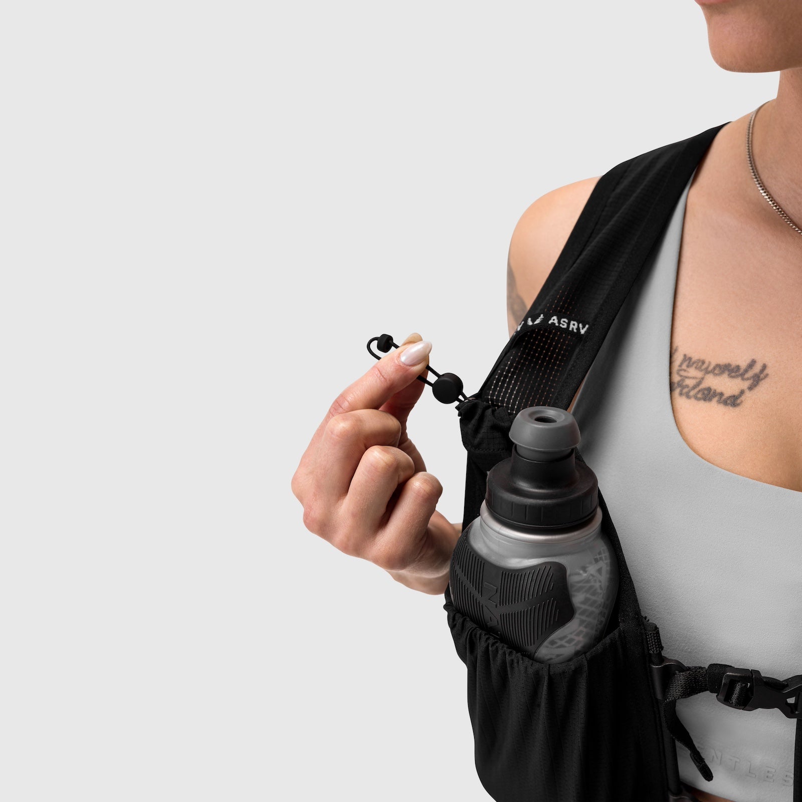 1080 Run Pack in black, worn on shoulder with water bottle detail