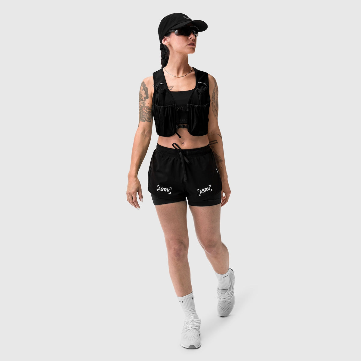 W025 Tetra-Lite Liner Short in black, modeled with matching vest and cap