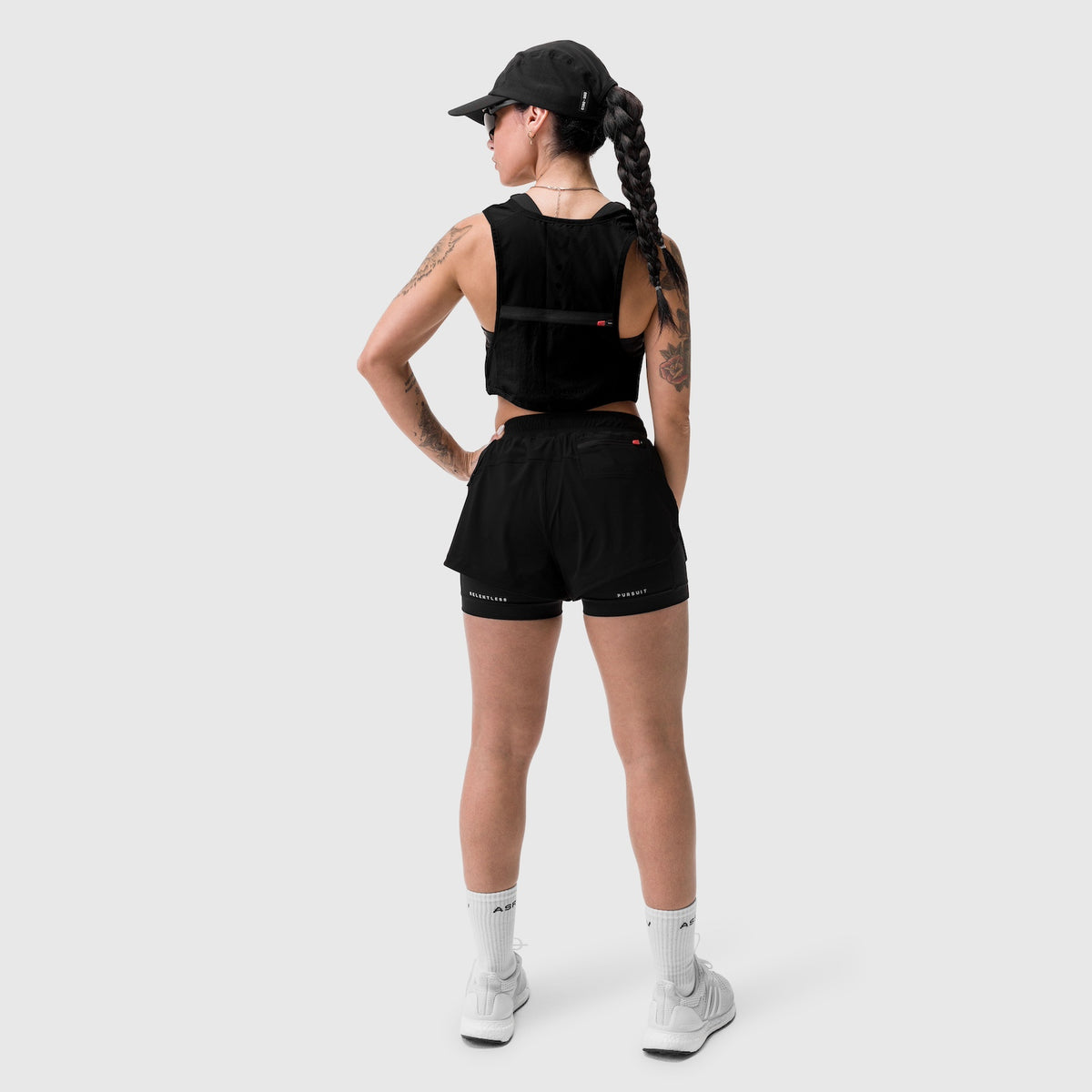W025 Tetra-Lite Liner Short in black, modeled from back view with white socks