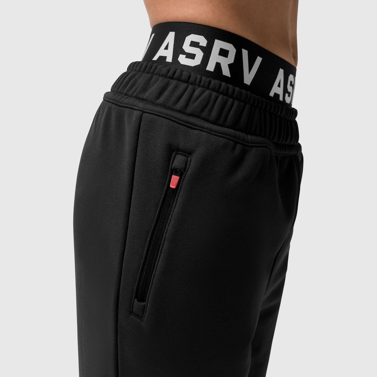 Black Sorona Terry straight leg sweats on model, waist detail with ASRV branding and zip pocket