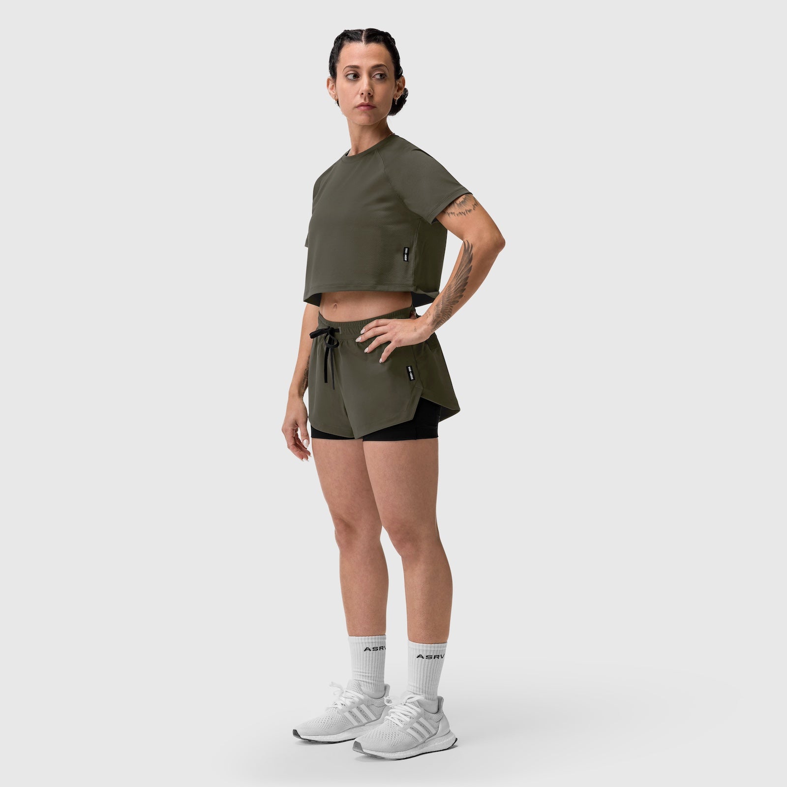 W025 Tetra-Lite Liner Short in olive, worn with cropped tee, front side view