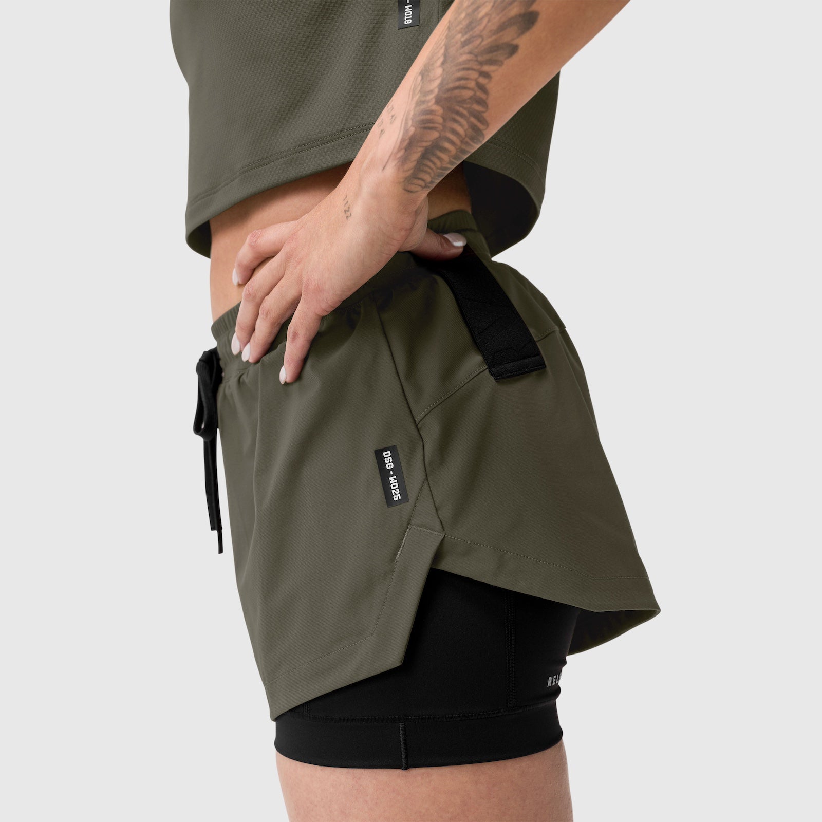 Tetra-Lite® Liner Short in olive worn by model, side view showing layered shorts design