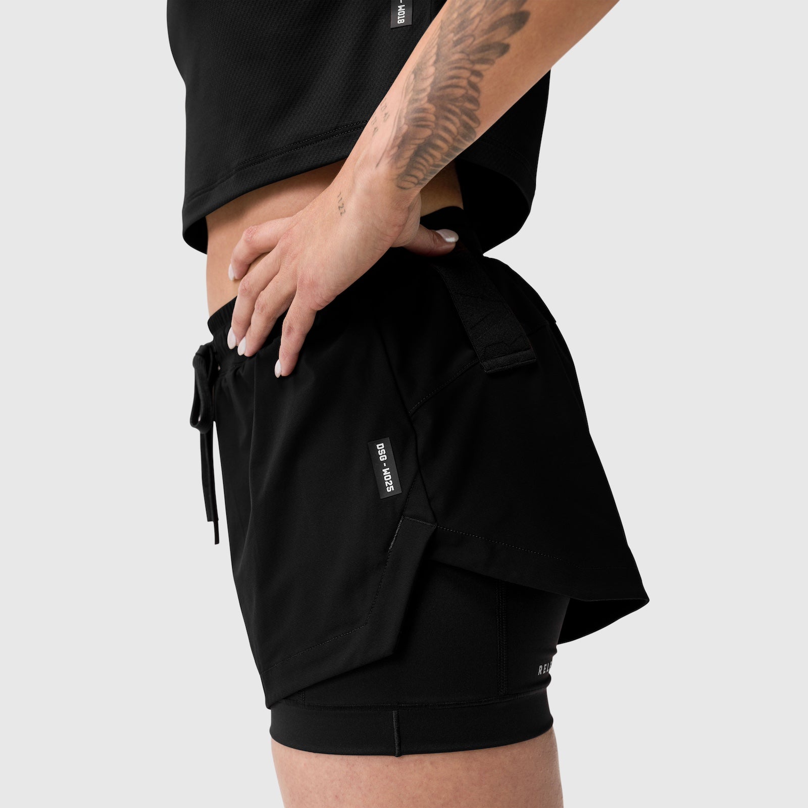 Black Tetra-Lite Liner Short worn by model, side view showing fit and pocket detail